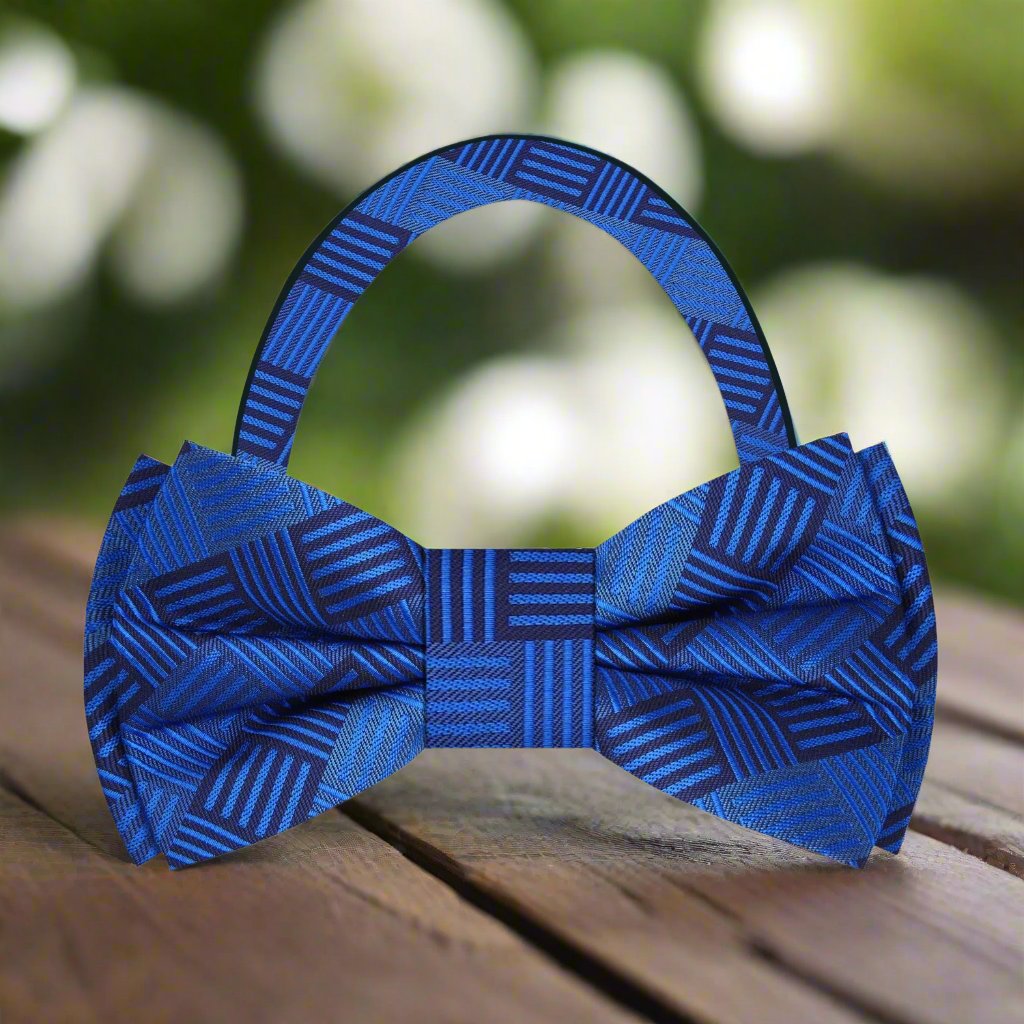 Close-up of blue geometric silk bow tie with detailed pattern