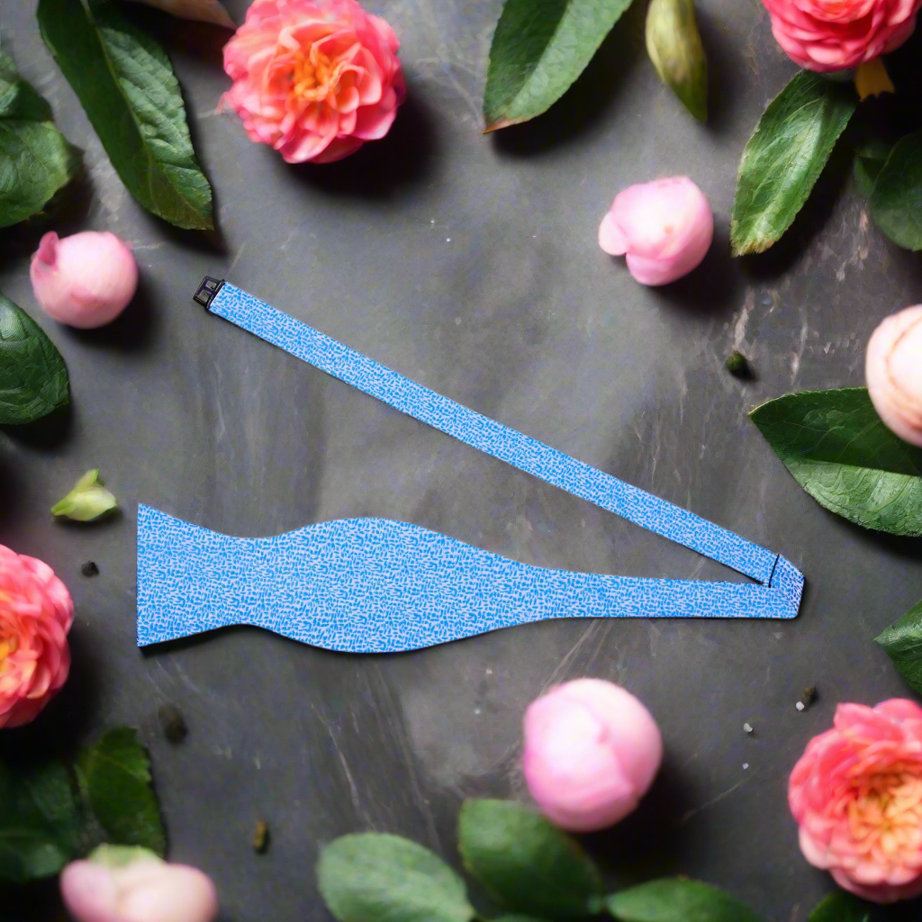Close-up of a blue textured bow tie, showcasing the intricate design and vibrant color.