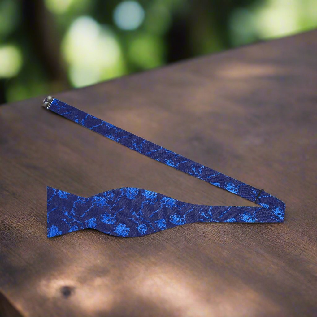 Navy blue silk bow tie with subtle abstract design, ideal for formal occasions
