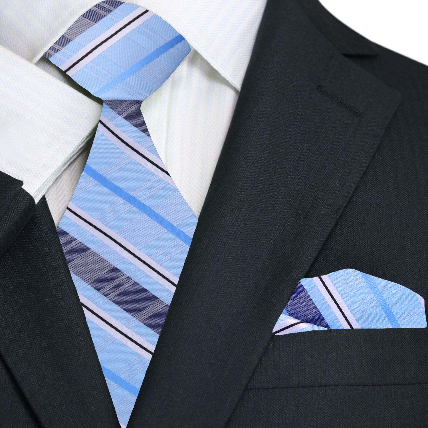 Man wearing a plaid silk necktie with a white dress shirt and navy blazer at a wedding