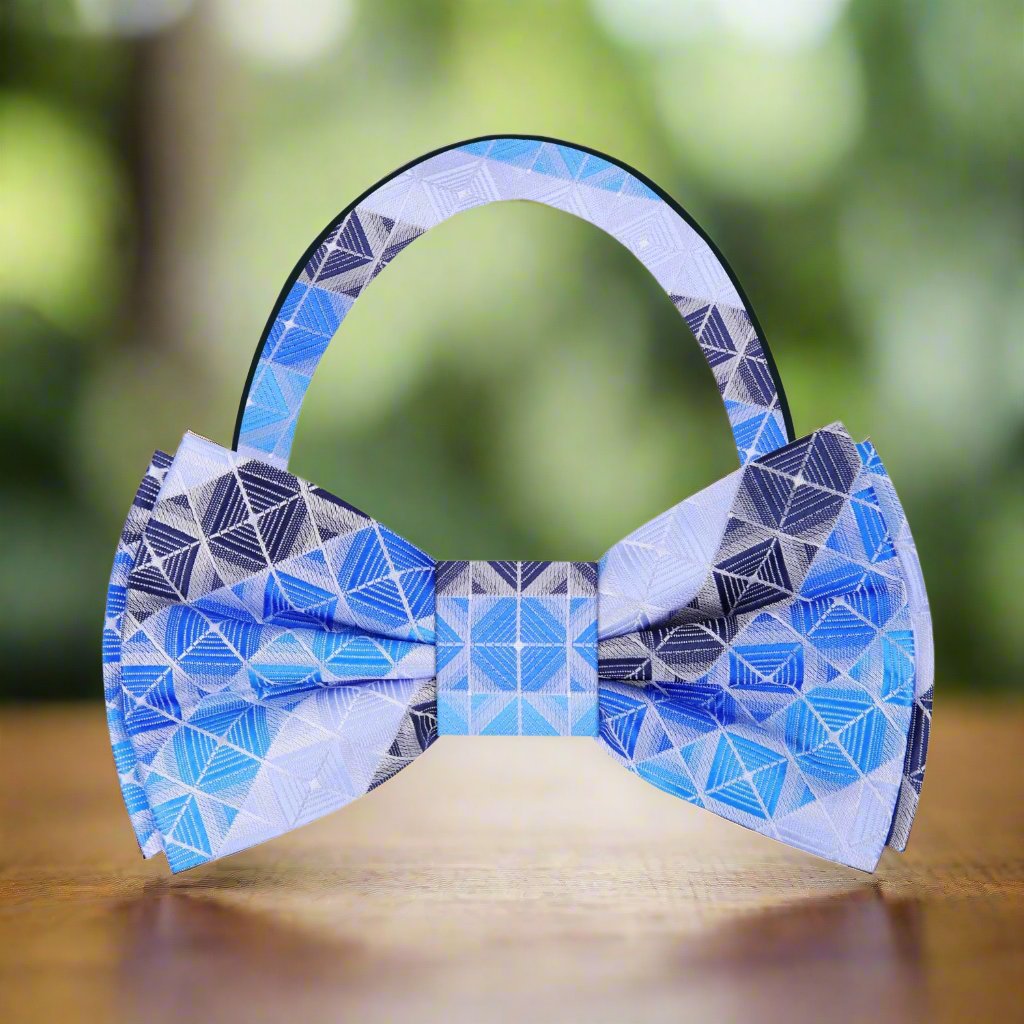 Stylish model wearing the blue geometric bow tie at a formal event, paired with a navy suit.