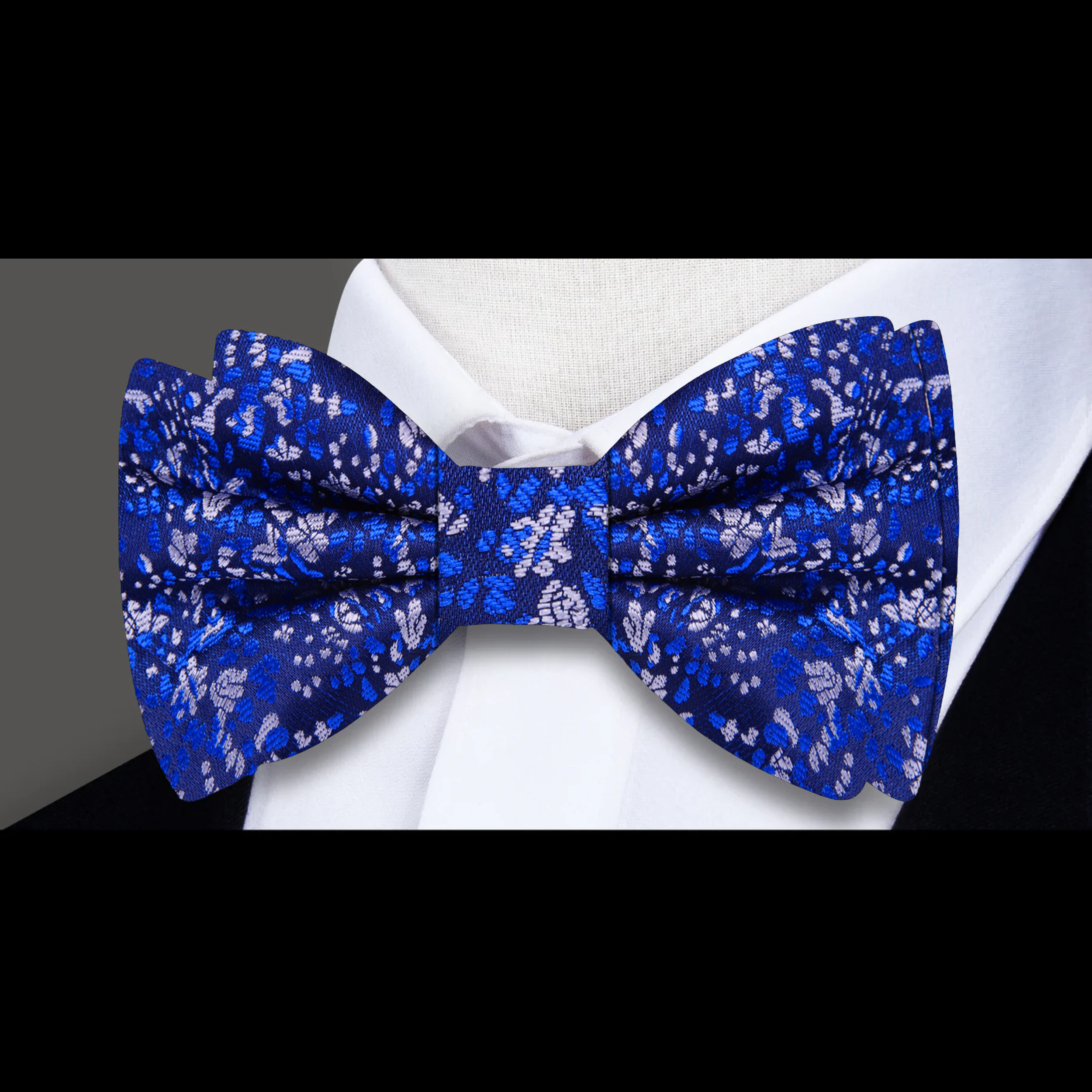 Close-up of adjustable silk bow tie with intricate floral design