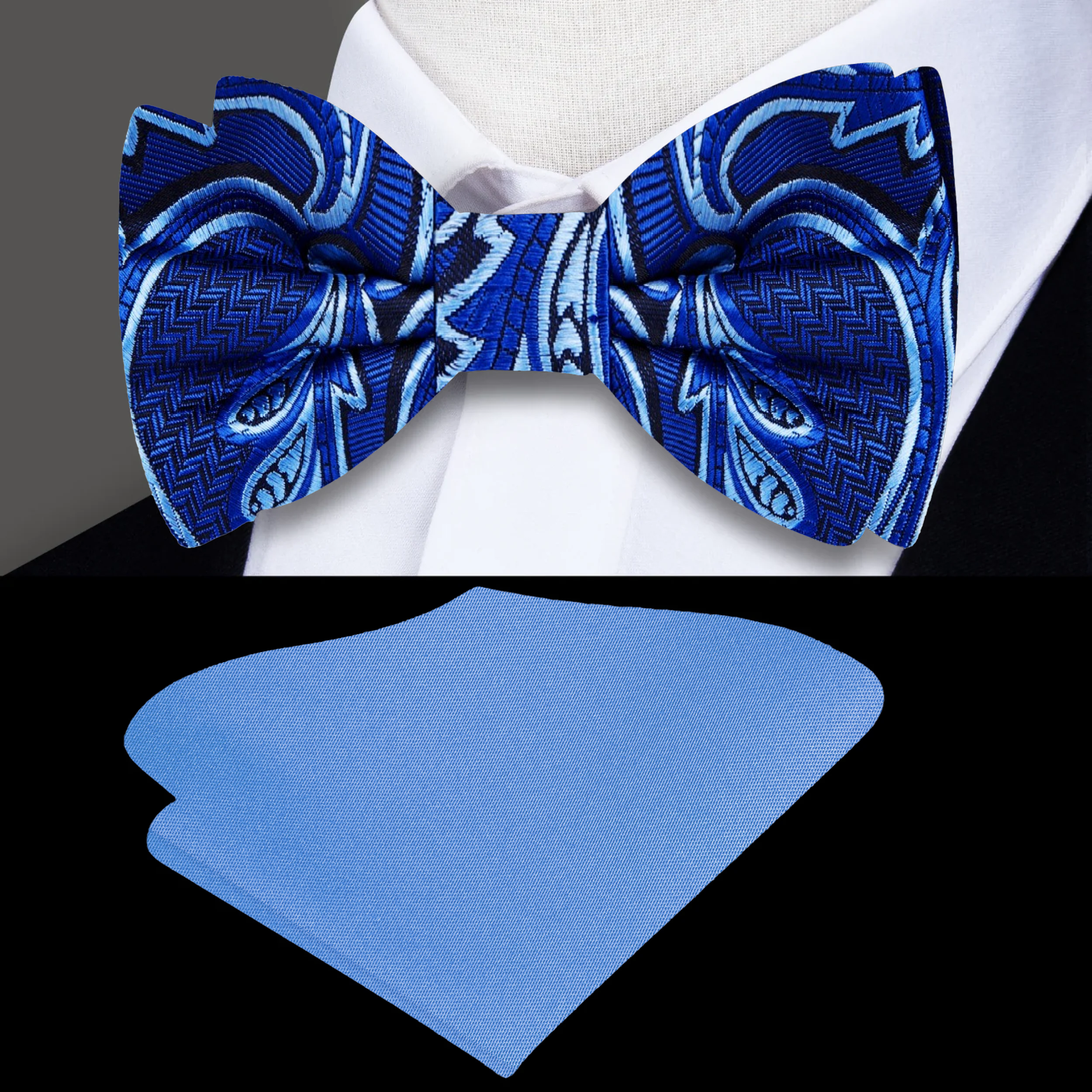 Elegant dark blue silk bow tie with white paisley pattern worn at a wedding.