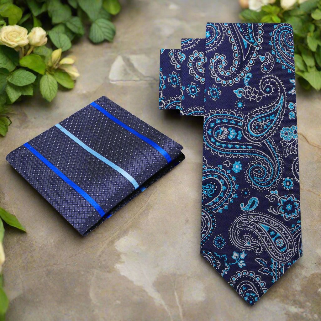 Elegant blue paisley silk necktie draped over a white shirt for formal wear