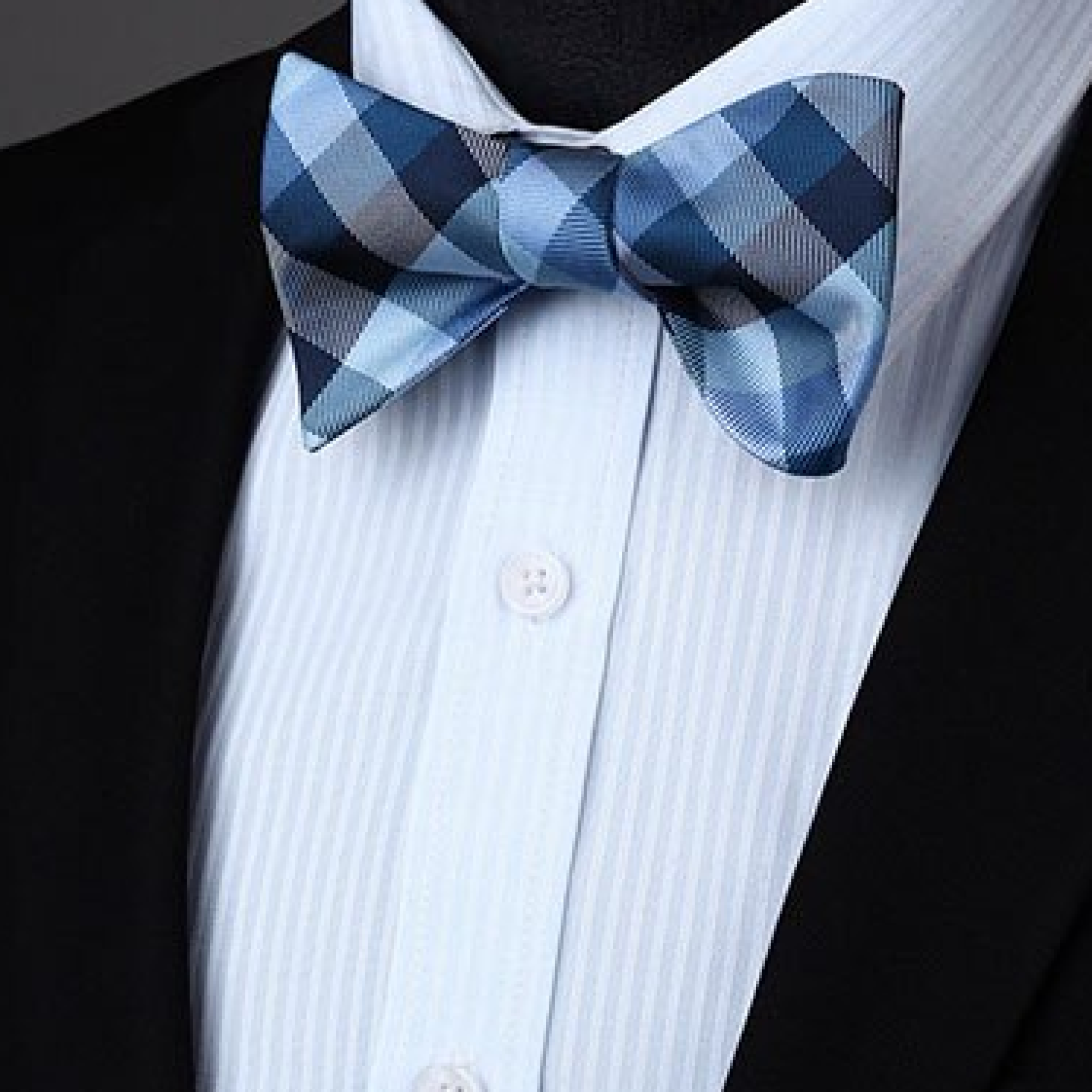 Styled shot of a geometric check bow tie paired with a classic suit for a sophisticated look