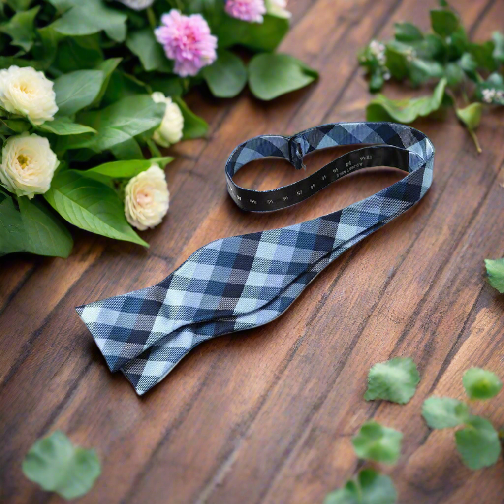 Close-up of a premium mens plaid bow tie with adjustable strap for formal attire