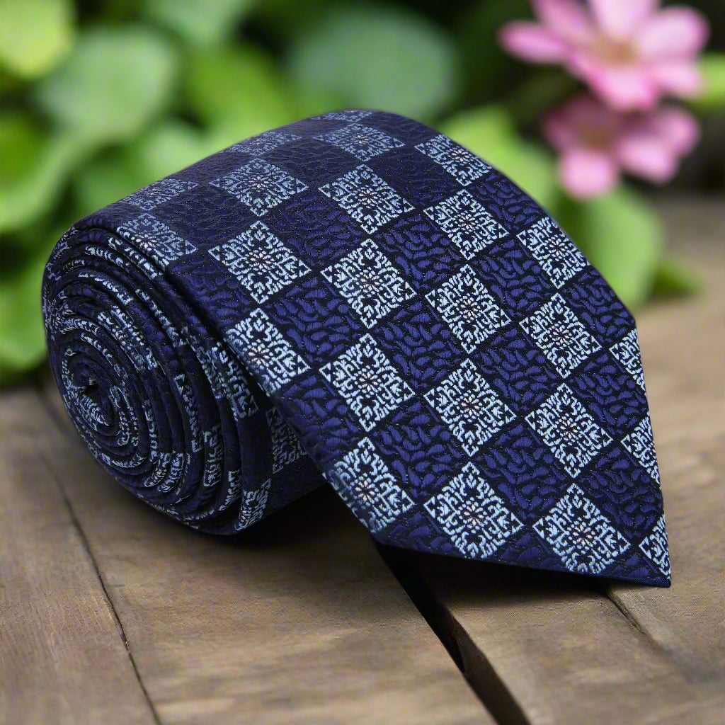 Front view of dark blue geometric silk necktie for men