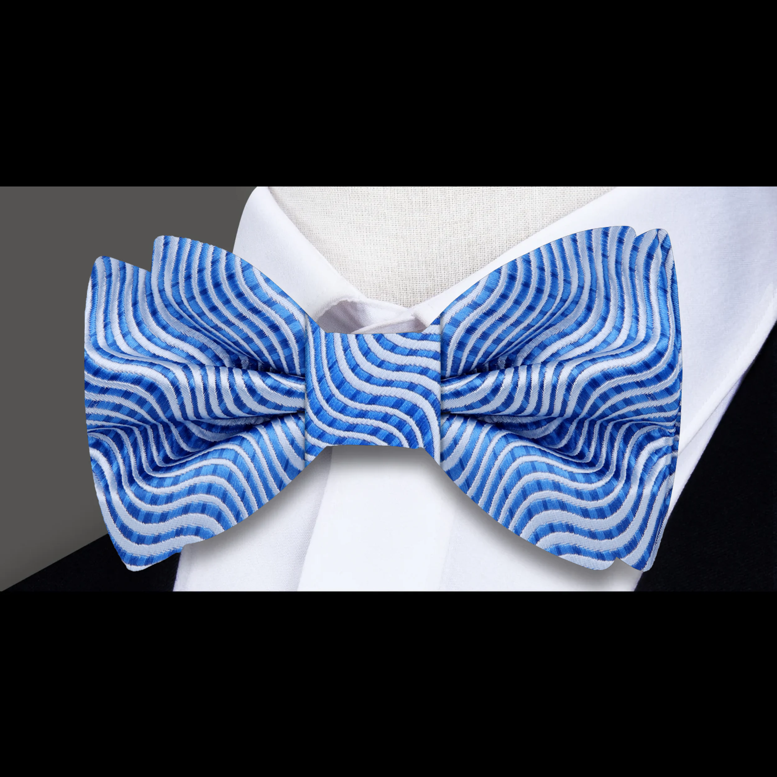 Close-up of the Azure Waves stylish bow tie and pocket square set, showcasing its elegant silk fabric.