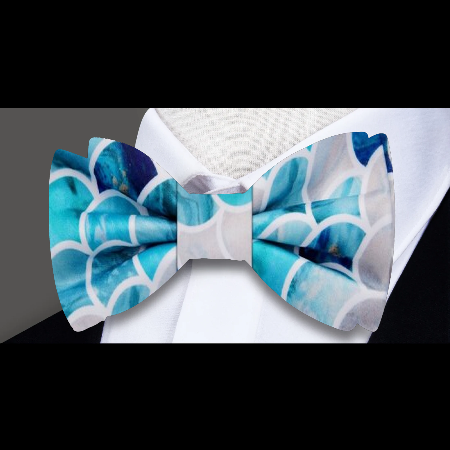 Silk bow tie in shades of aqua, ideal for summer garden parties.