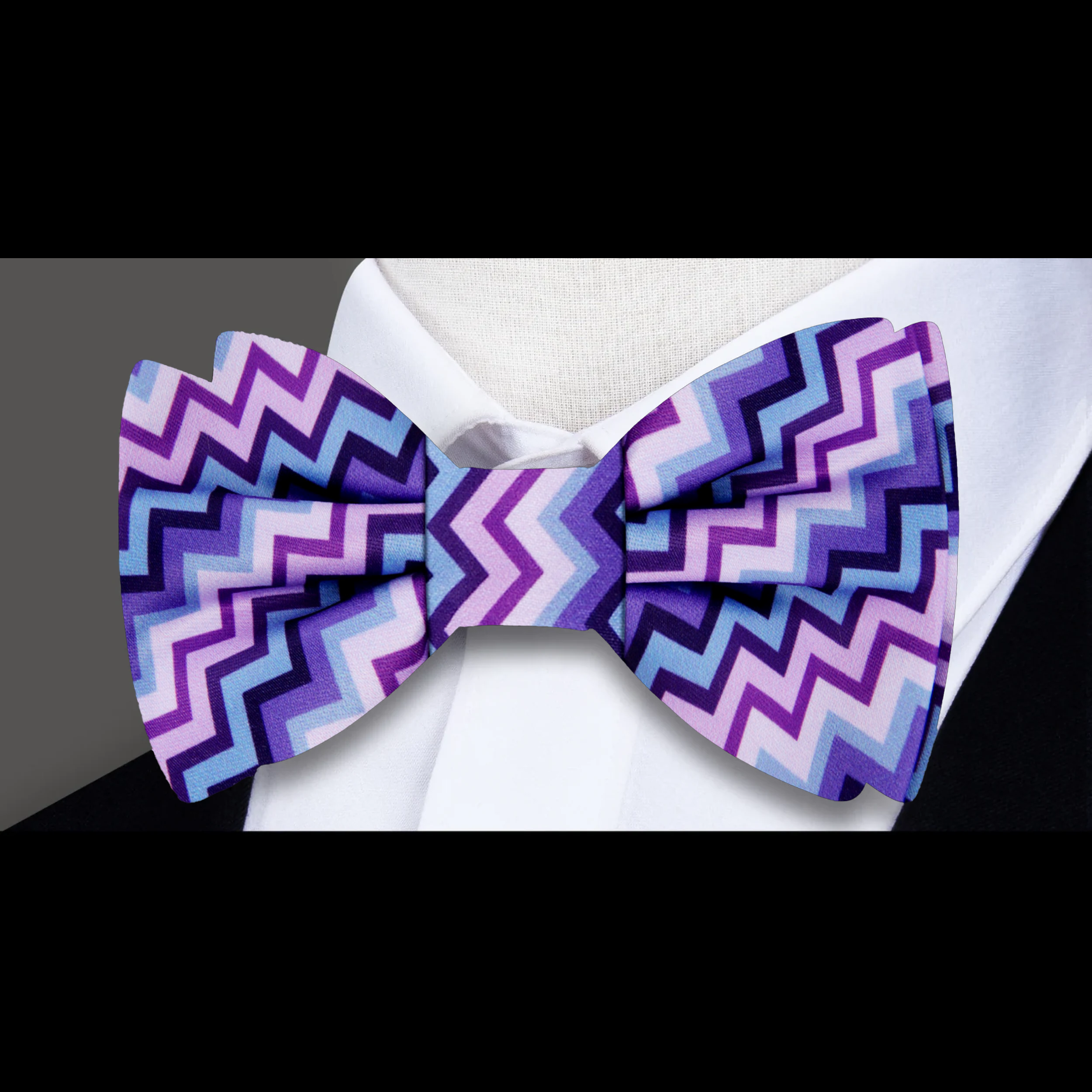 Close-up of Thrive pink and purple silk bow tie with jagged pattern, perfect for weddings