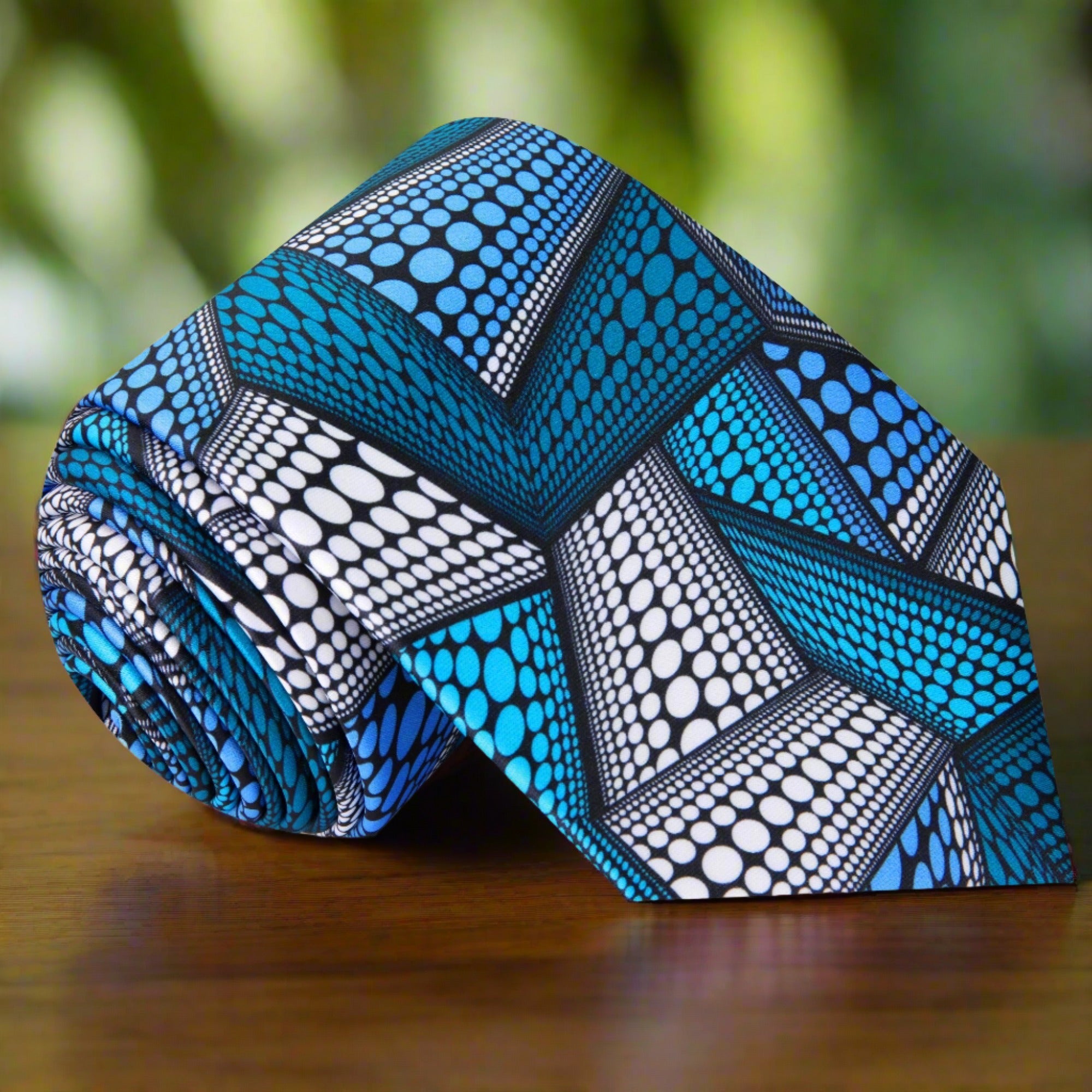 Close-up of Kente Elegance Necktie featuring intricate blue and white patterns.