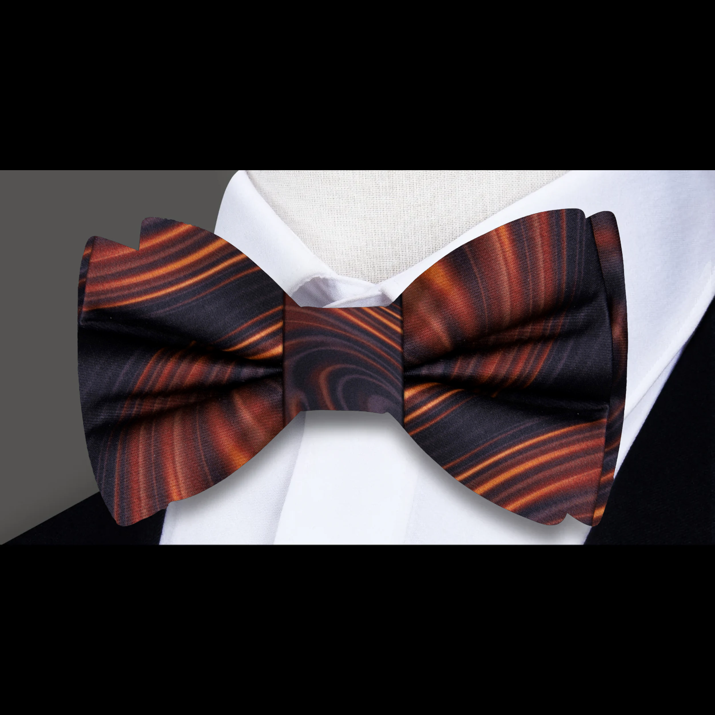 Close-up of caramel swirl silk bow tie showing detailed pattern