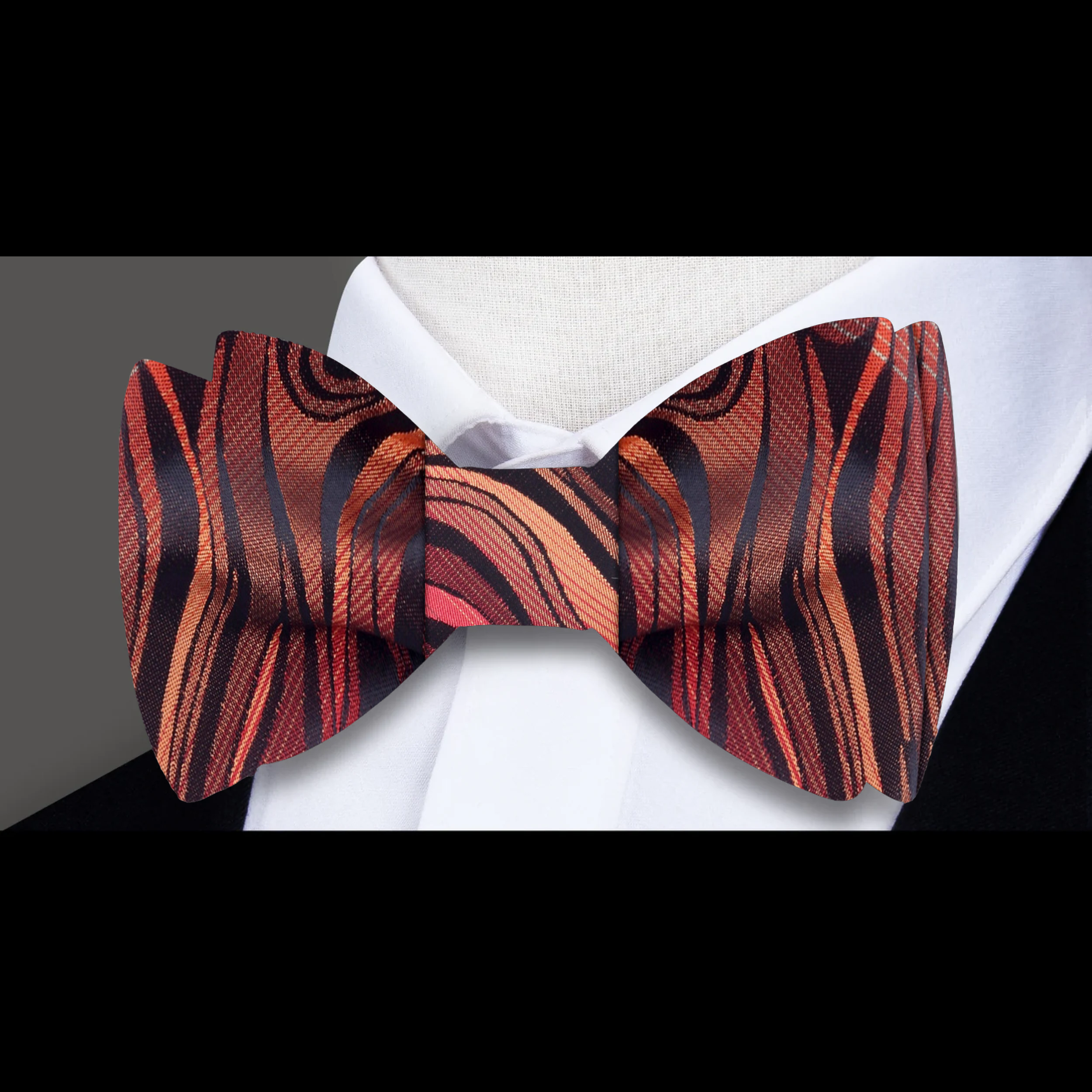 Styled bow tie paired with crisp white shirt and charcoal grey suit for cocktail party