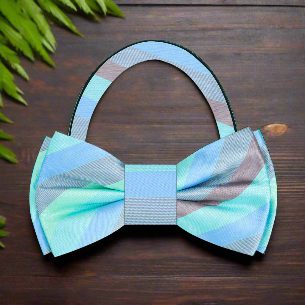 Close-up of charming pastel striped bow tie against a light background.