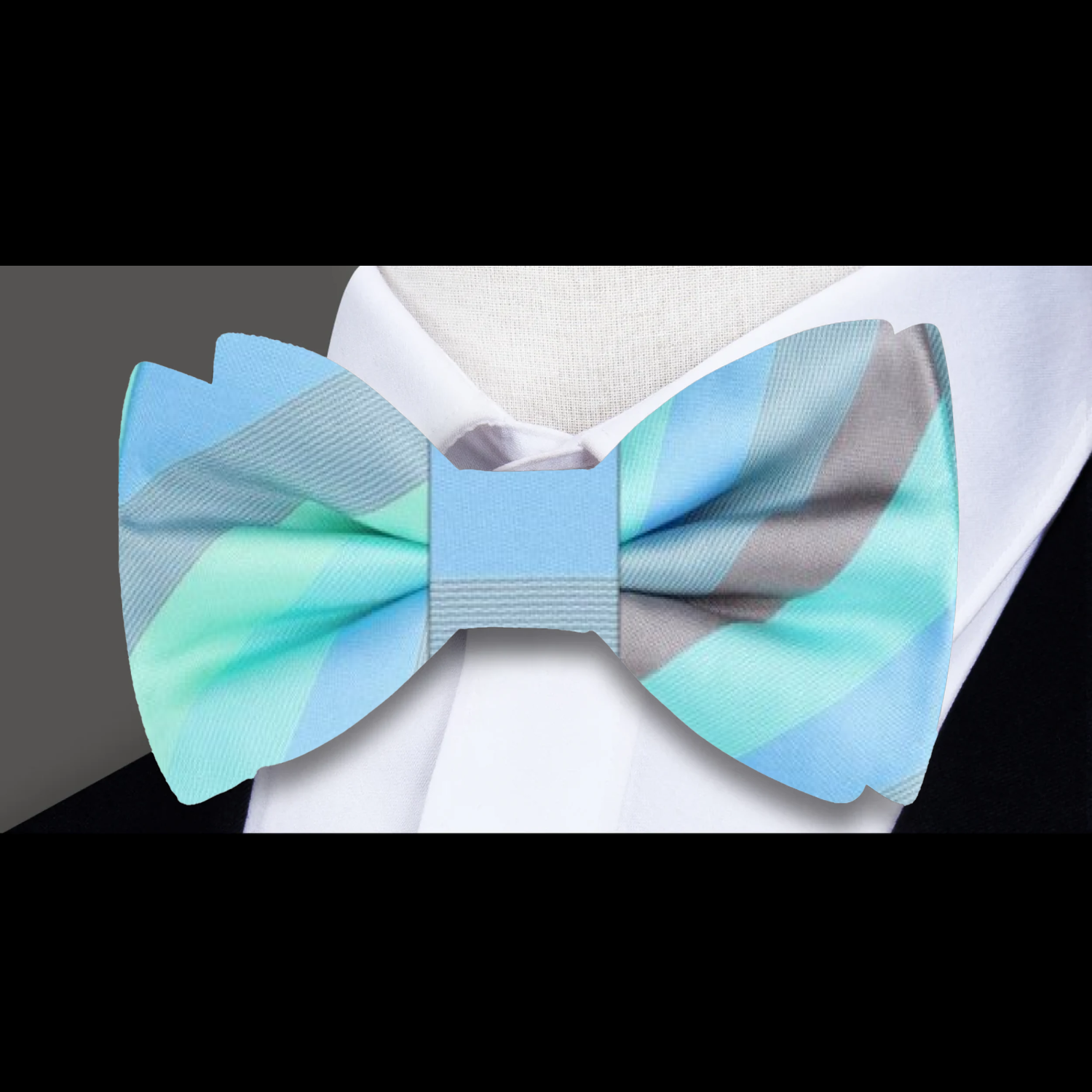 Elegant pastel striped bow tie styled on a crisp white dress shirt.