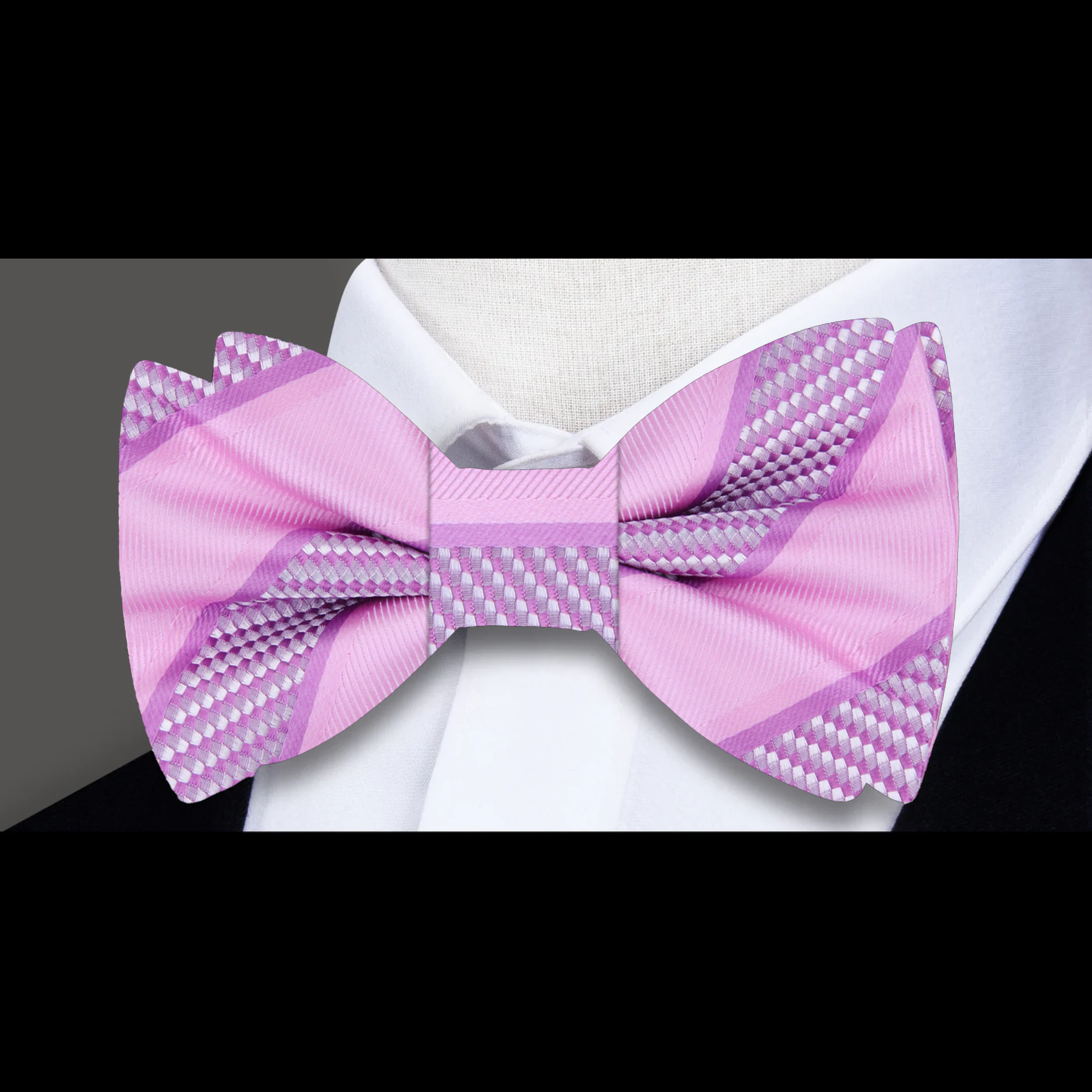 Close-up of the fabric pattern and texture of a yellow gold striped bow tie