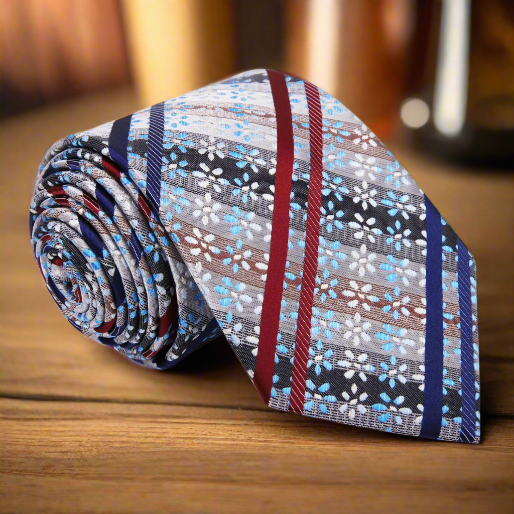 Front angle of Namje silk tie showcasing red, blue, and white floral stripes.
