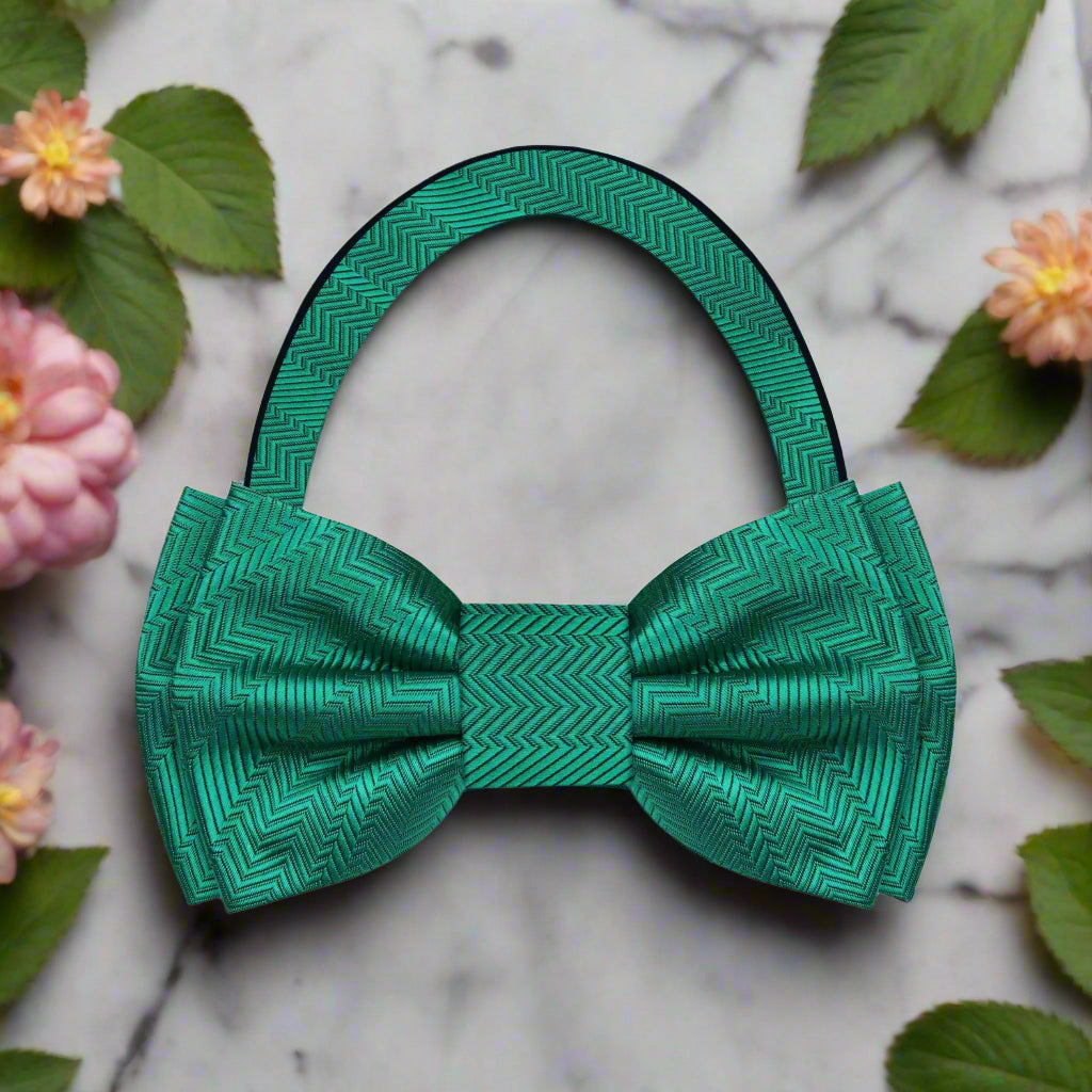 Close-up of a deep pine green silk bow tie, showcasing its smooth texture and elegant design.