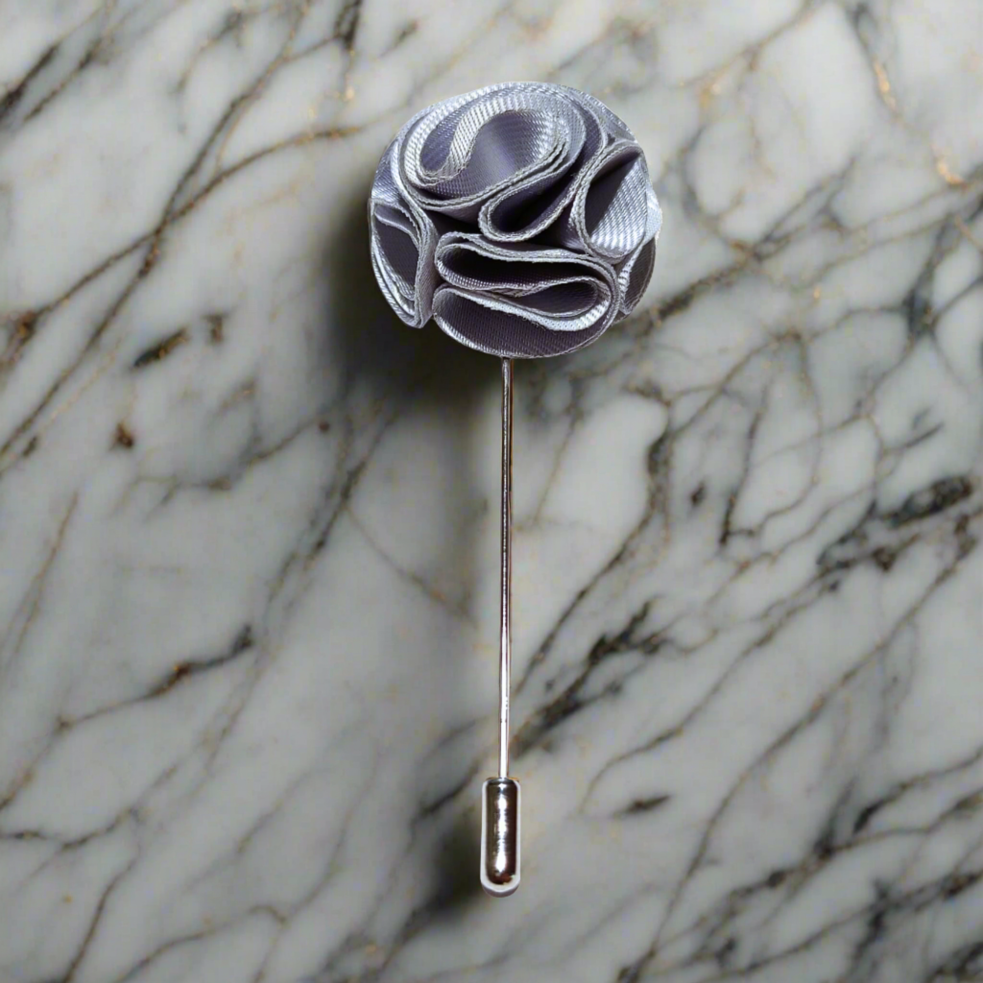 Close-up of a high-quality flower pin with textured fabric and zinc alloy backing