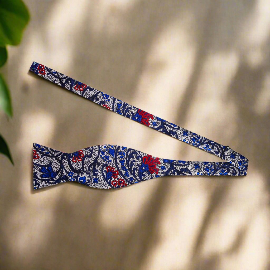 Stylishly arranged bow tie and pocket square set against a classic white dress shirt.