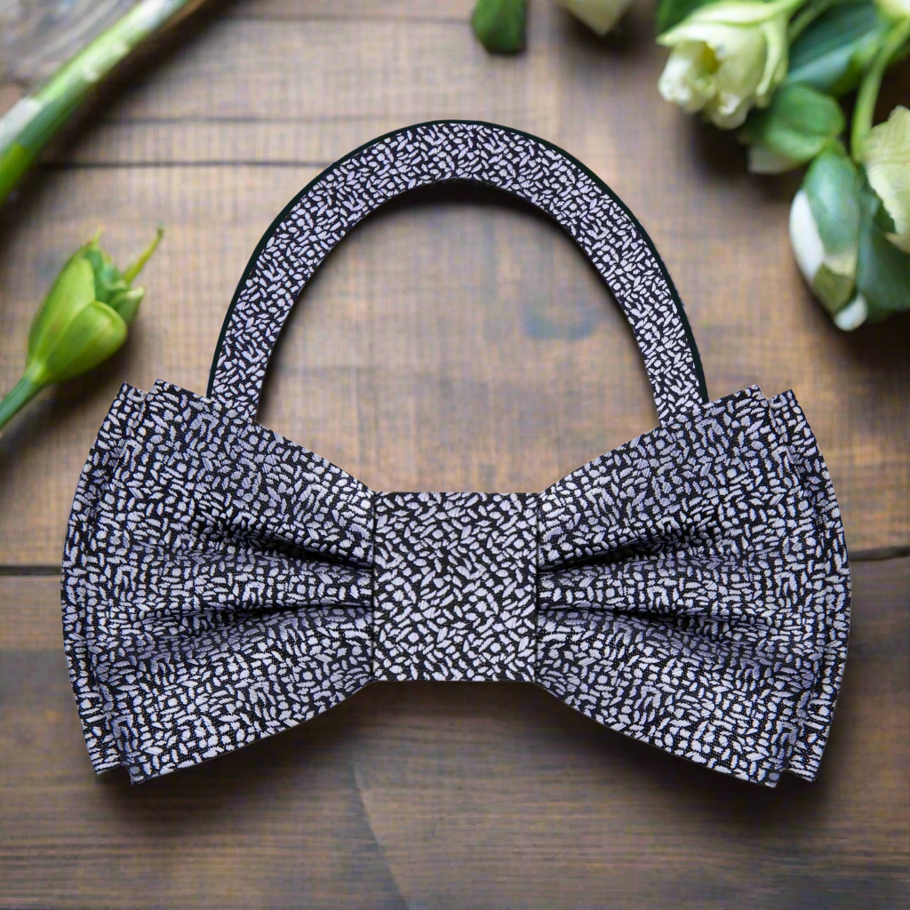 Man adjusting a classic self-tie silk bow tie for a formal event
