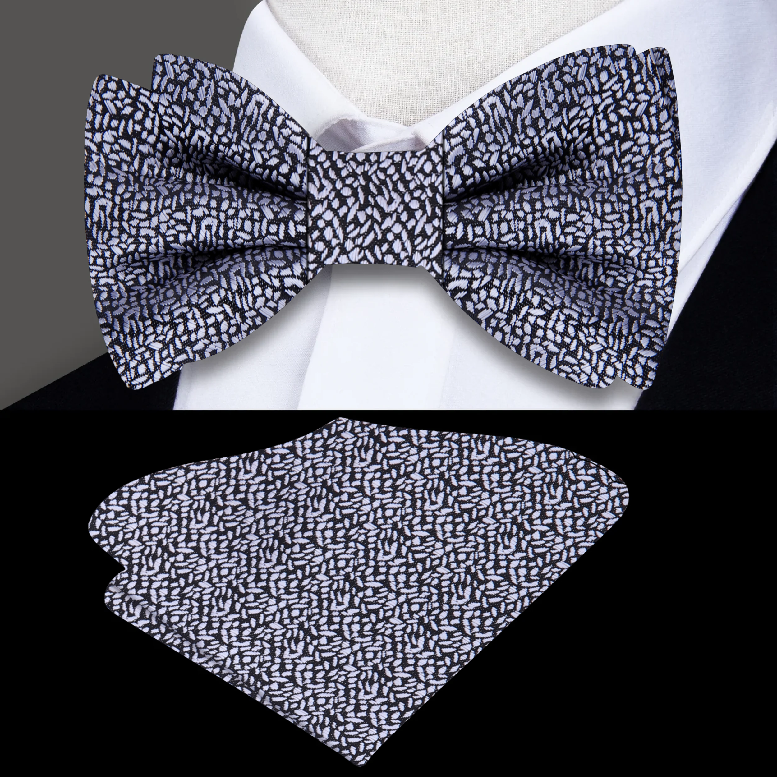 Close-up view of a grey textured silk bow tie with detailed fabric pattern