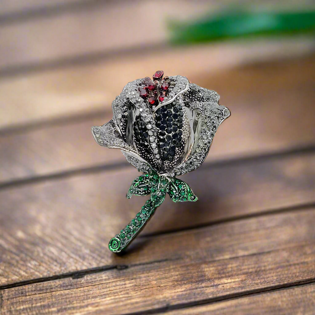 Elegant rose lapel pin in classic red, perfect for formal suits.