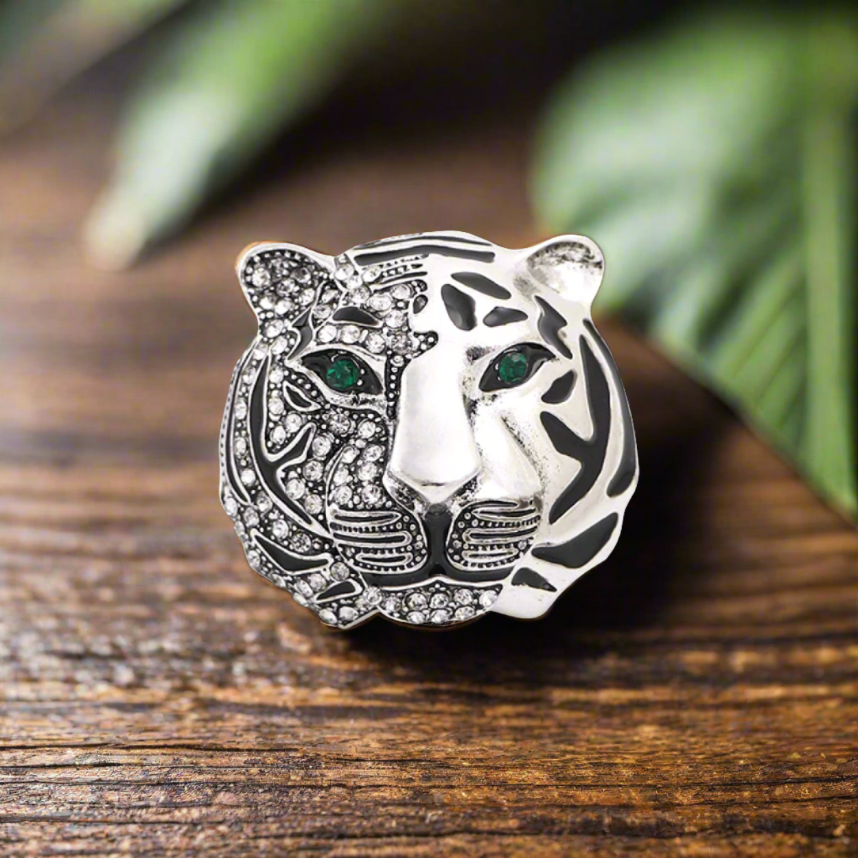 Close-up of a gold tiger head lapel pin with gemstones, showing intricate details and luxury appeal