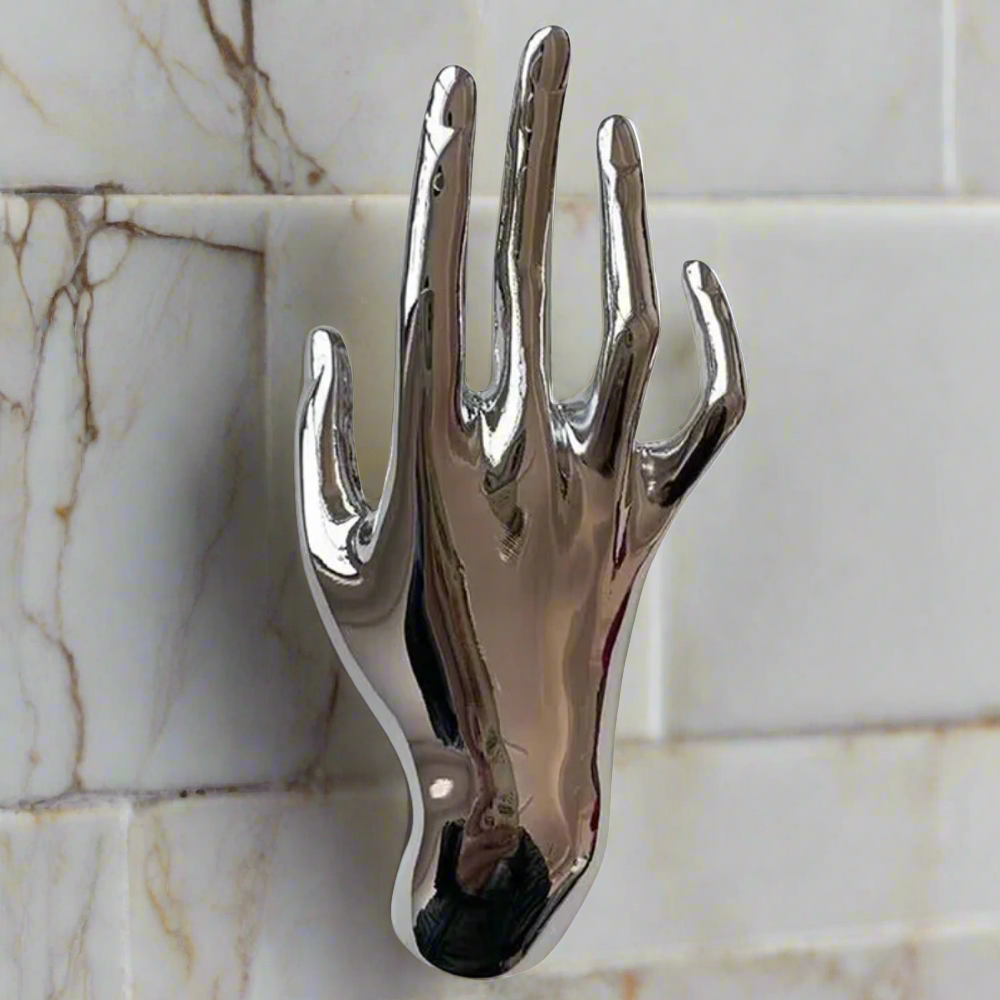 Gold hand lapel pin on a mens suit lapel, close-up shot