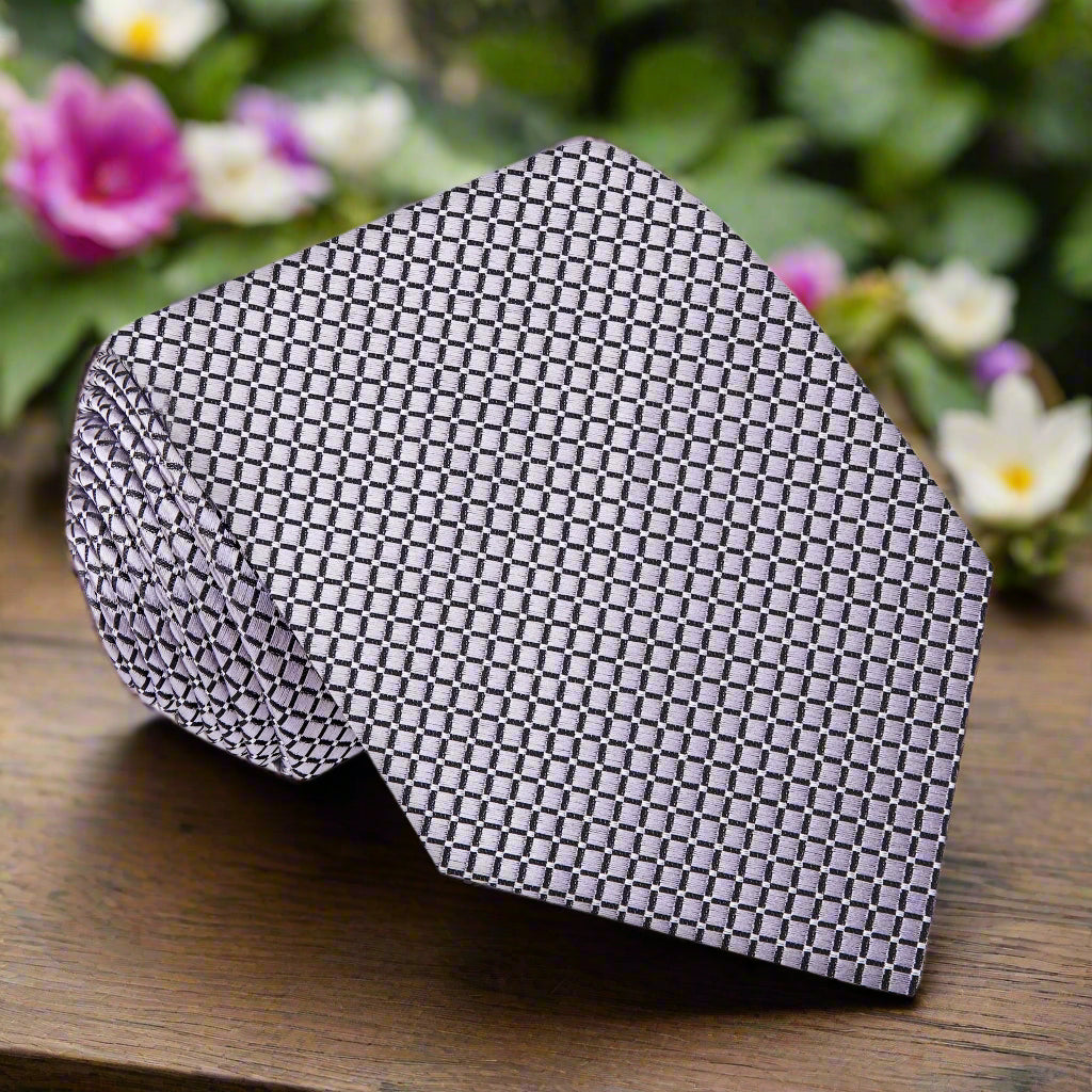 Close-up of the elegant silver geometric necktie showcasing its premium silk fabric and subtle pattern.