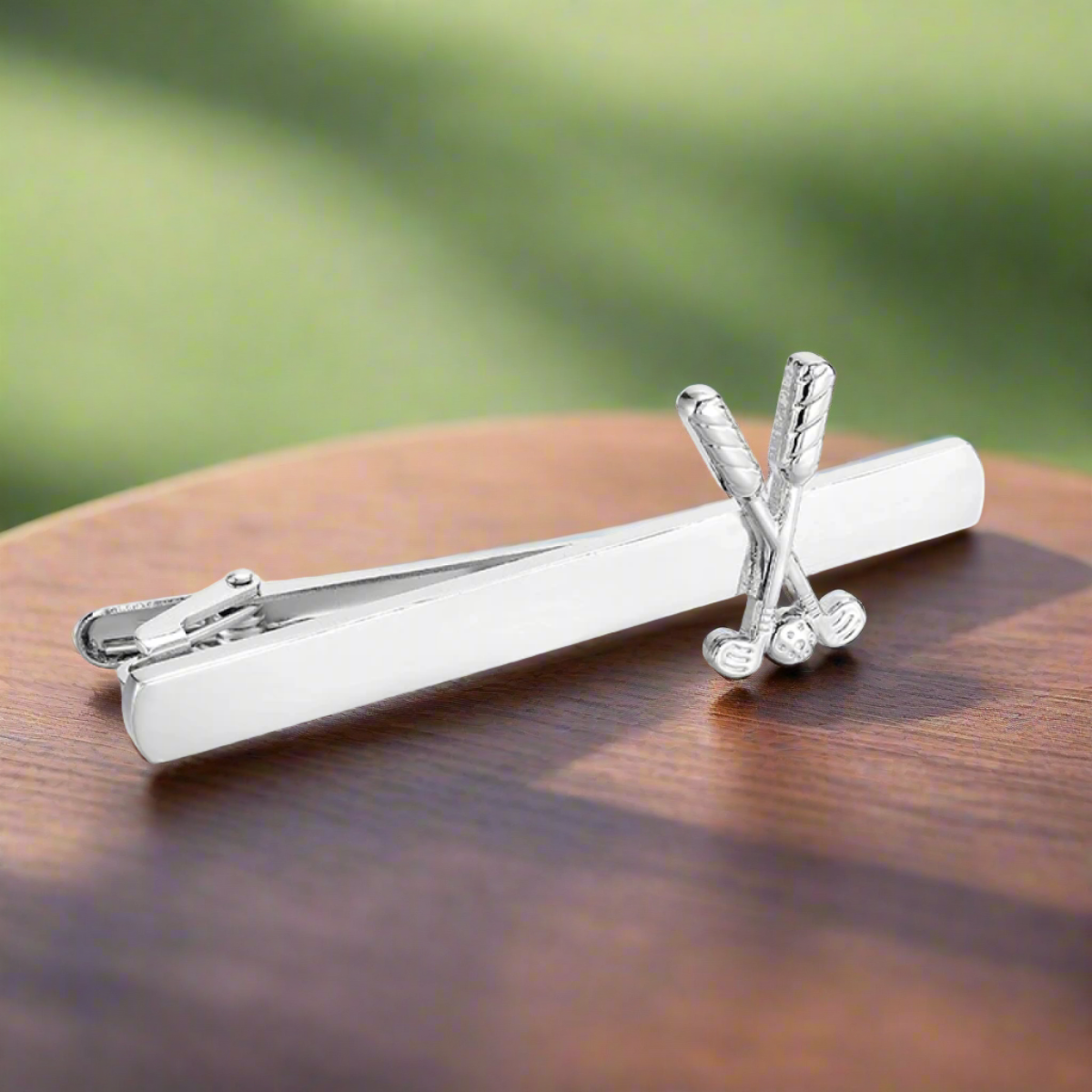 Close-up of a silver golf tie clip on a white shirt for formal golf events