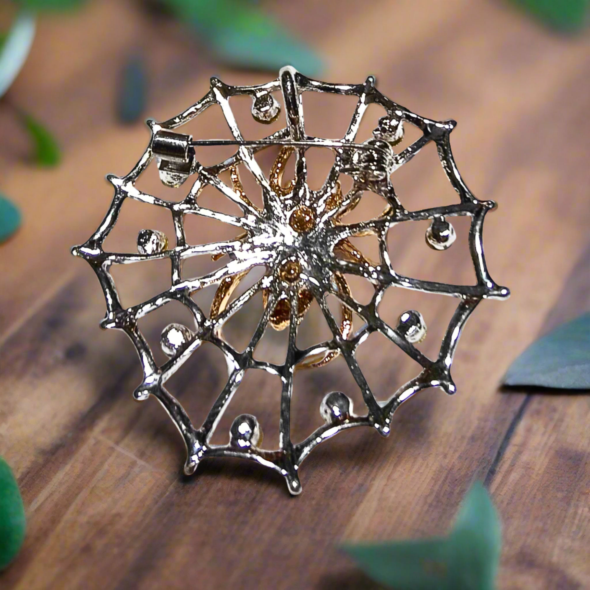 Front view of silver and gold spider web lapel pin on a suit jacket