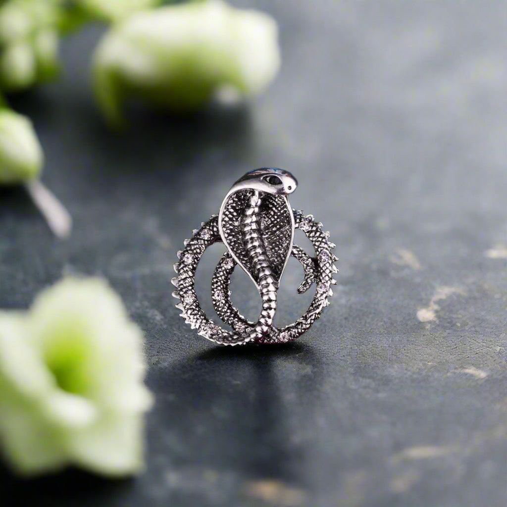 Close-up of the detailed scales and hood of the cobra lapel pin