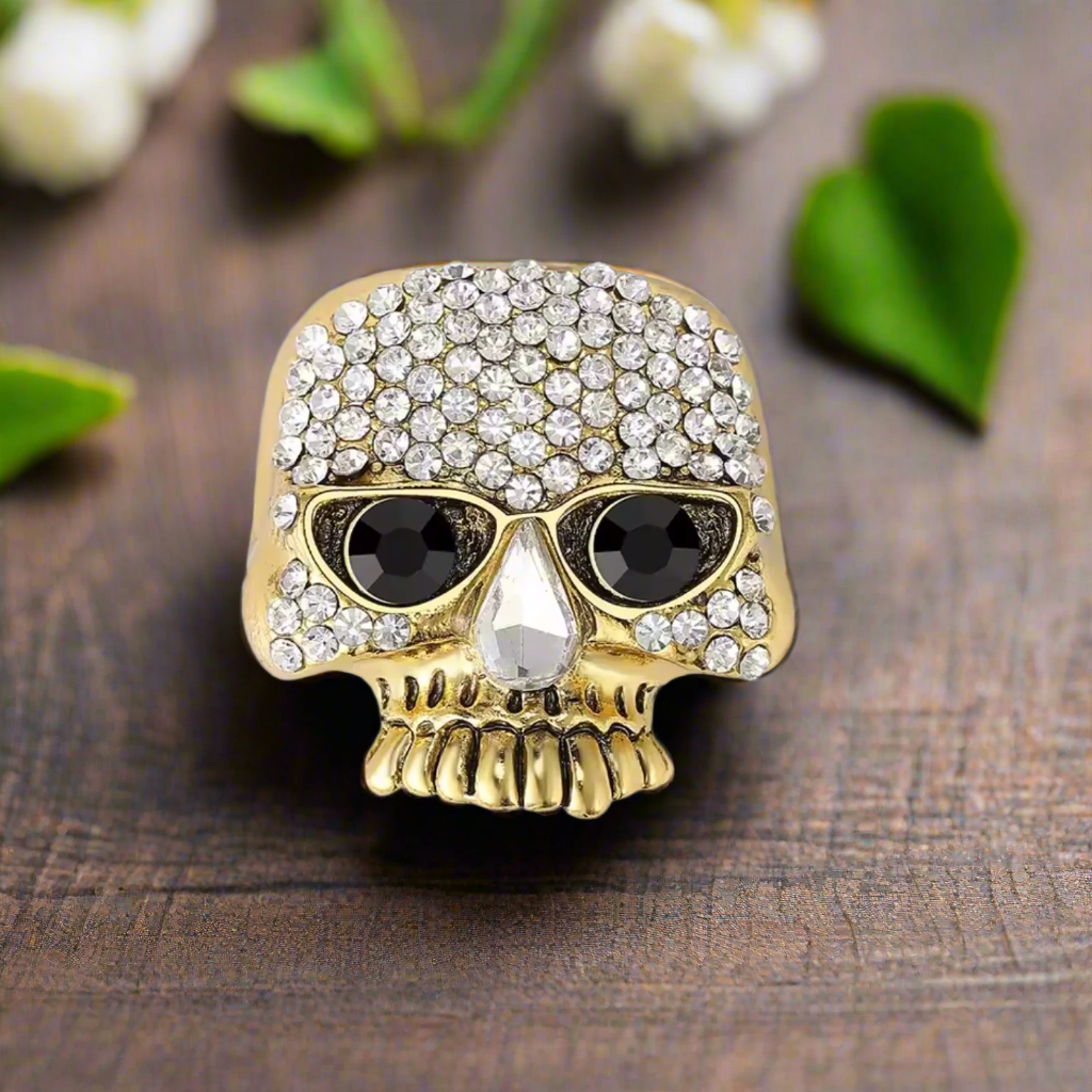 Skull lapel pin worn on a black dress shirt at a rock concert.