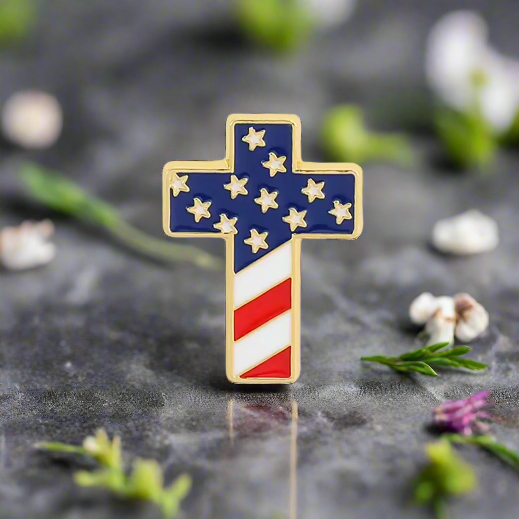 Front view of a patriotic cross lapel pin with American flag colors