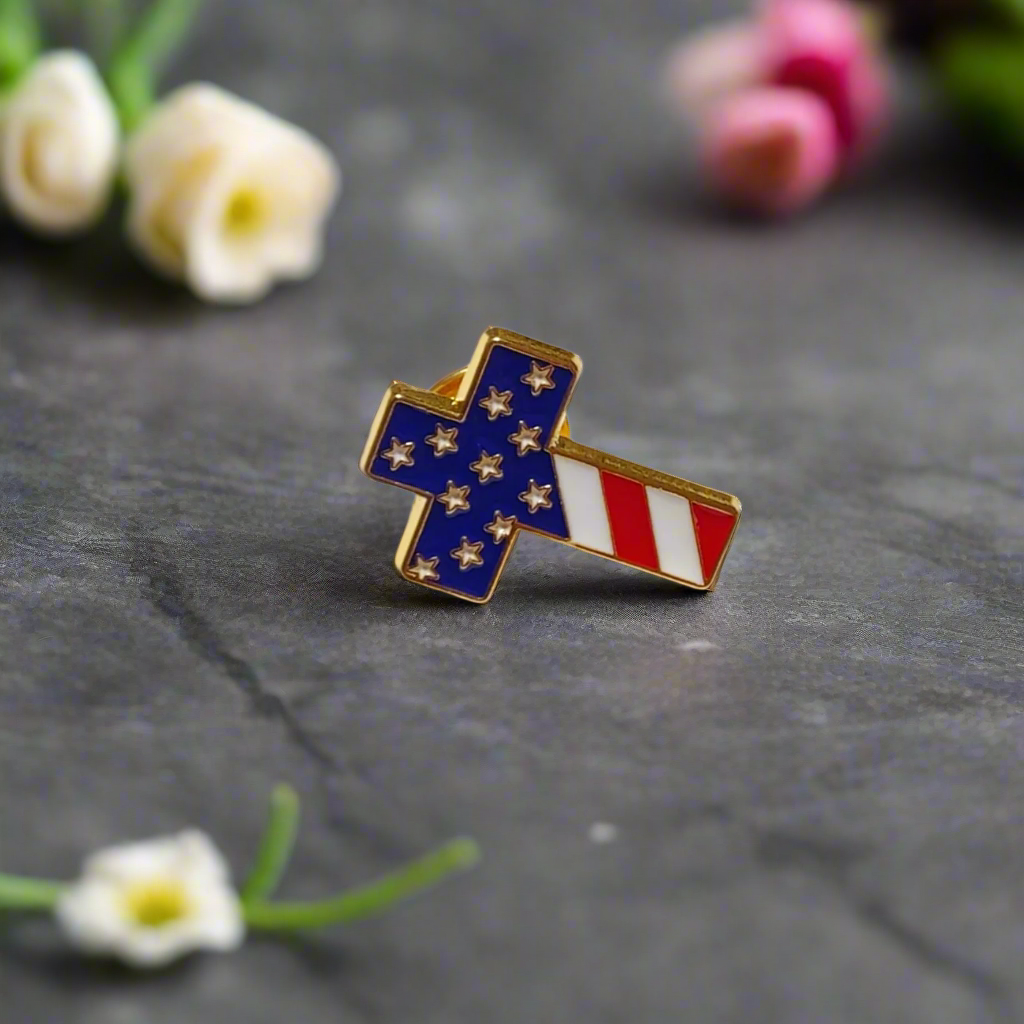Front view of a patriotic cross lapel pin with American flag colors