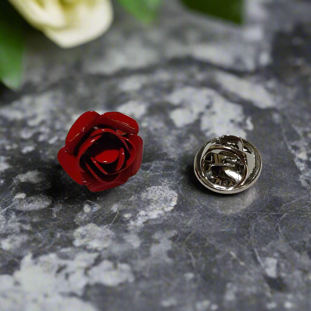 Red rose lapel pin styled on a crisp white dress shirt for a classic look.