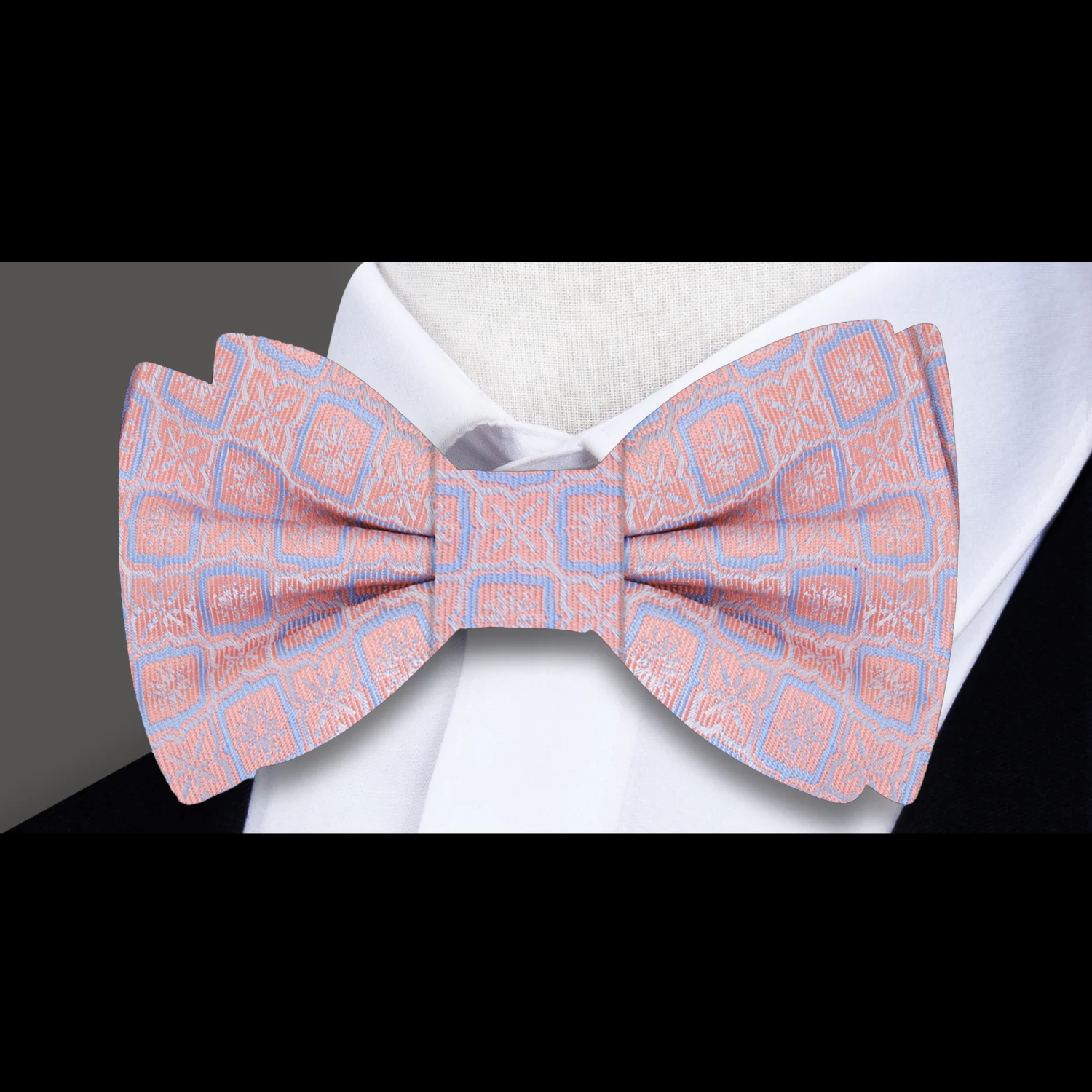 Model wearing the vibrant geometric silk bow tie with a light blue dress shirt at a wedding.