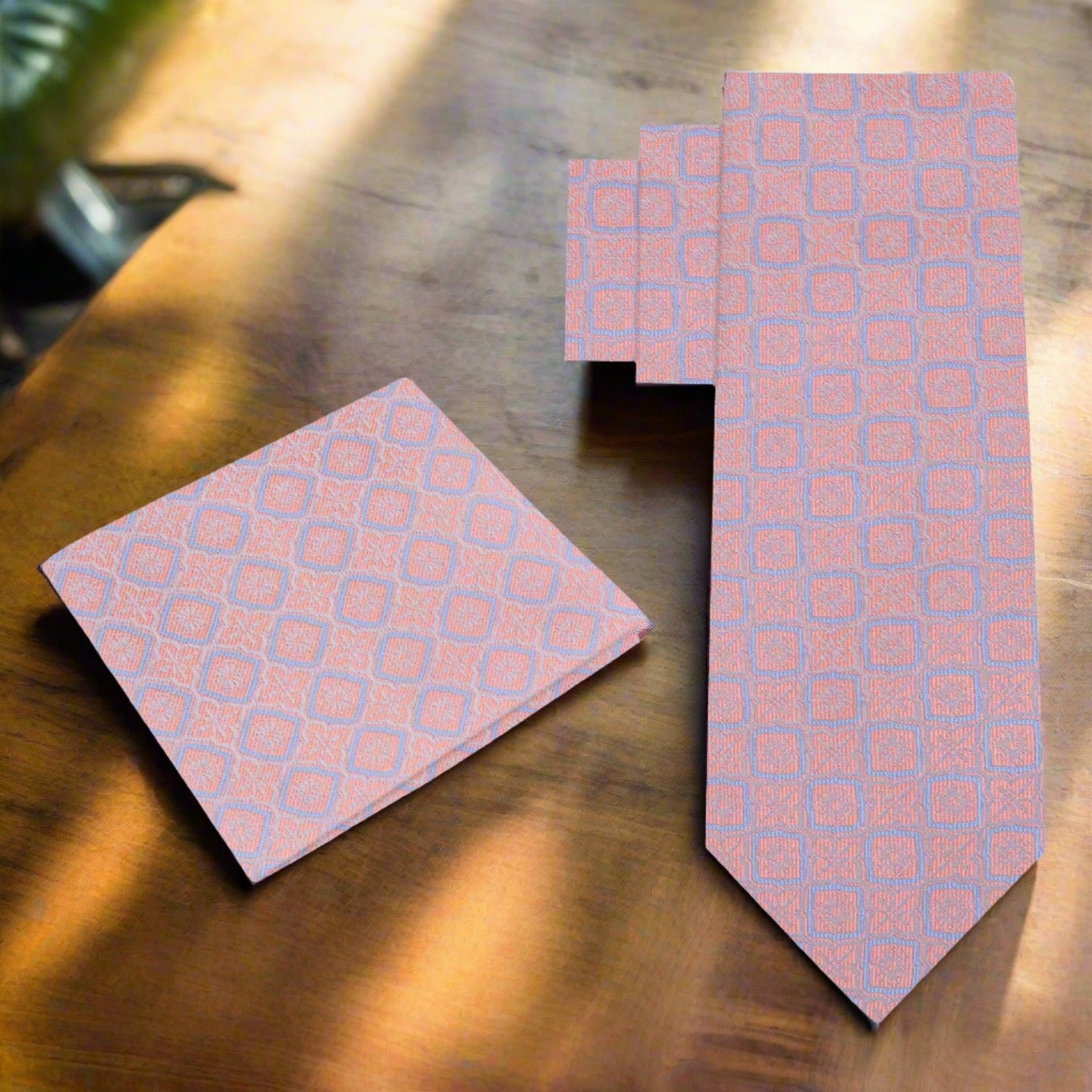 Close-up of geometric pattern silk necktie in peach pink on a display mannequin