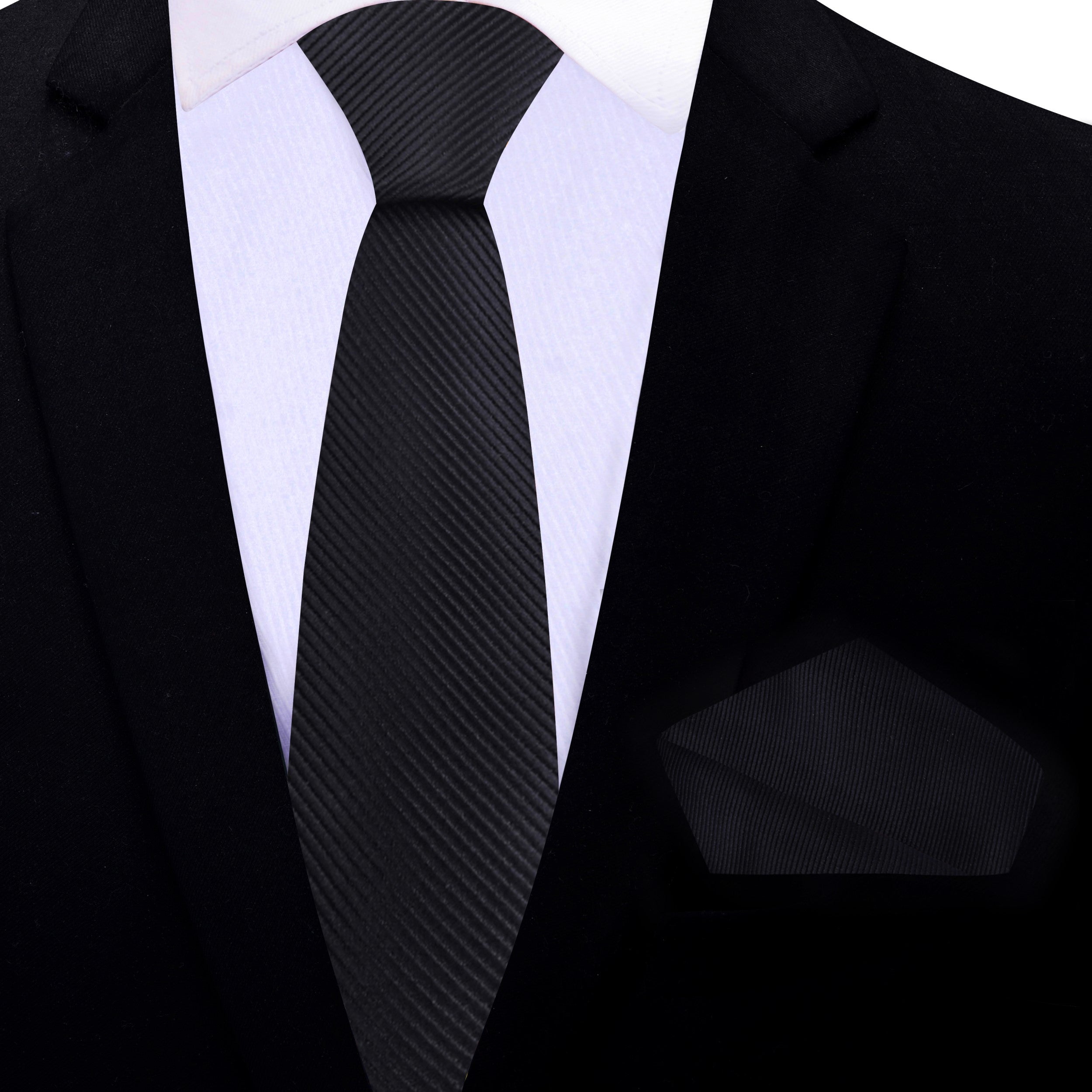 Elegant Solid Black Silk Necktie laid flat next to a pocket square, highlighting its versatility for various outfits.
