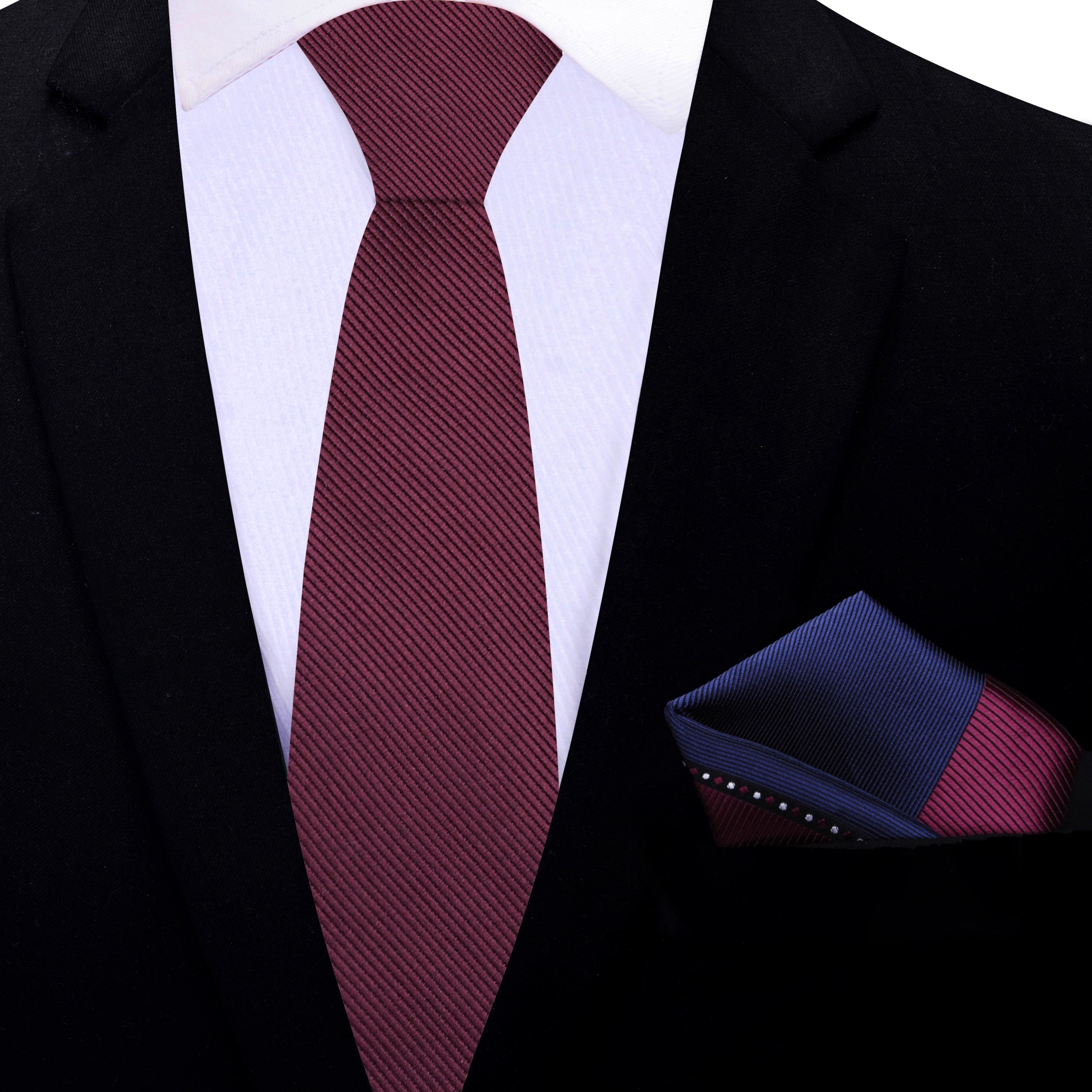 Stylishly arranged deep malbec necktie with a light blue dress shirt and charcoal grey suit, ideal for business settings.