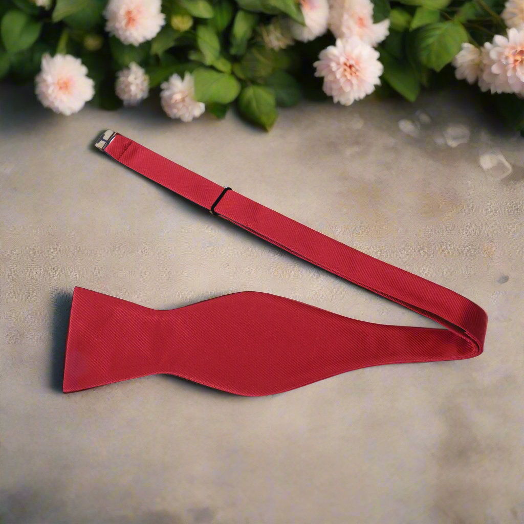 Red bow tie with pocket square set styled with a crisp white dress shirt and charcoal grey suit.