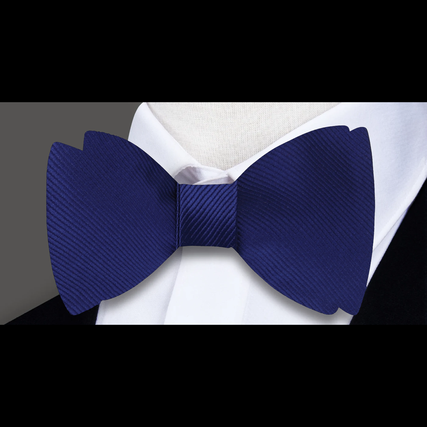Classic solid color bow tie in royal blue, perfect for formal events.