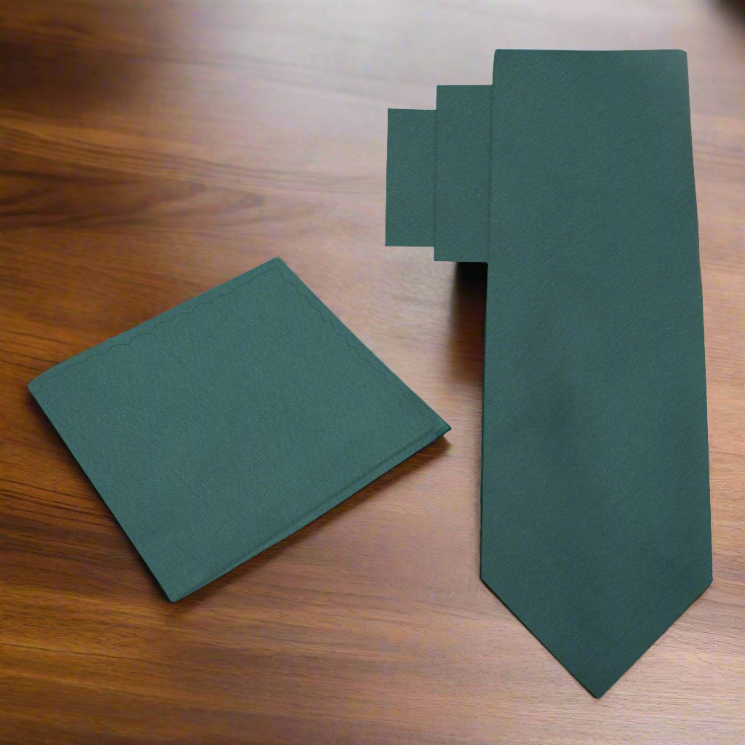 Deep forest green silk necktie displayed on a white shirt for formal wear