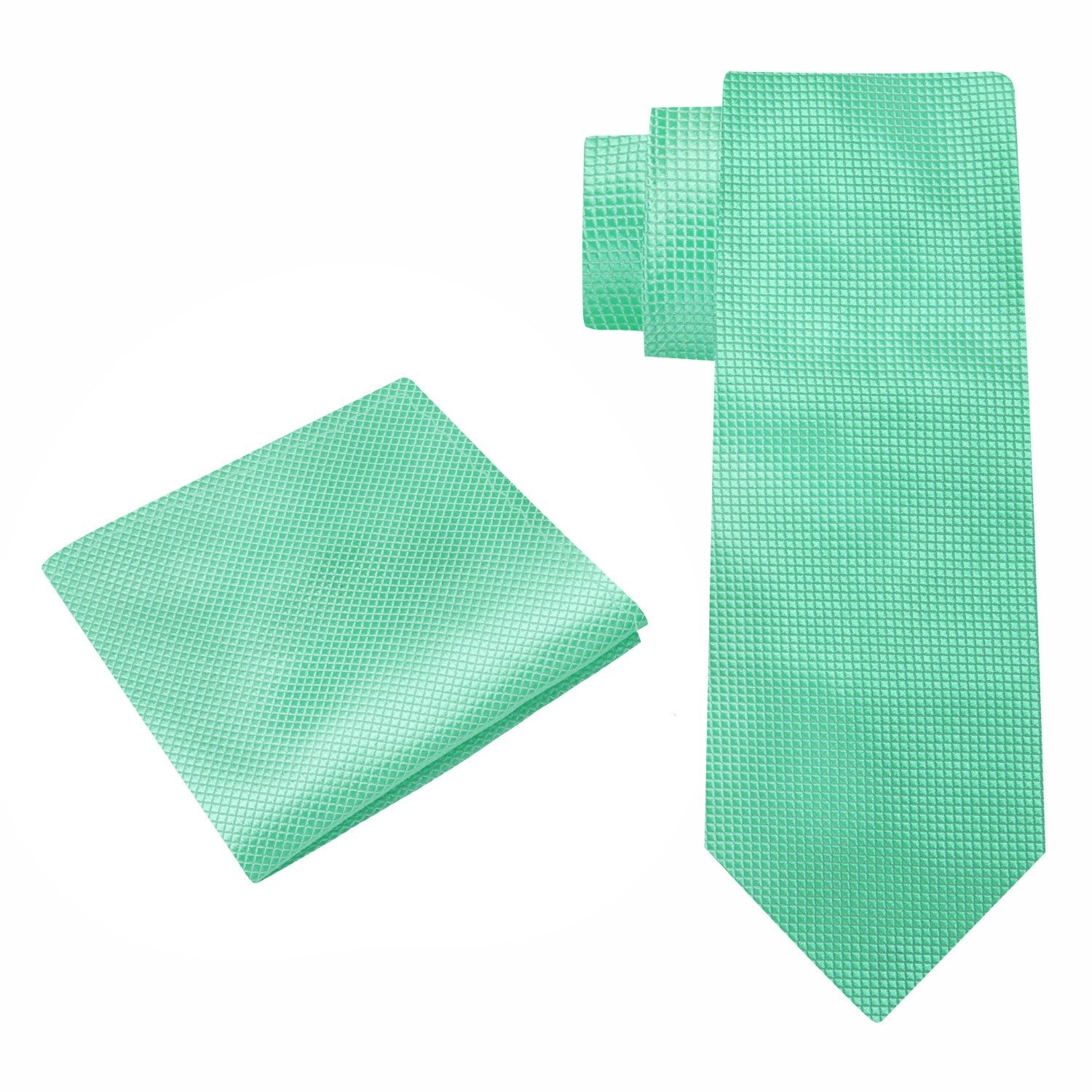 Close-up of a childs hand tying a silk necktie with matching pocket square