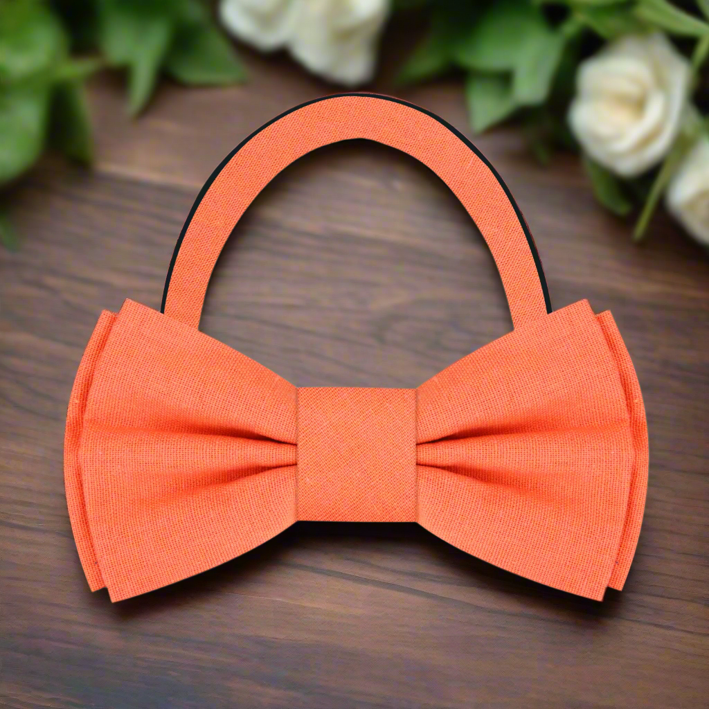 Fashionable man adjusting a deep red linen bow tie, showcasing effortless elegance