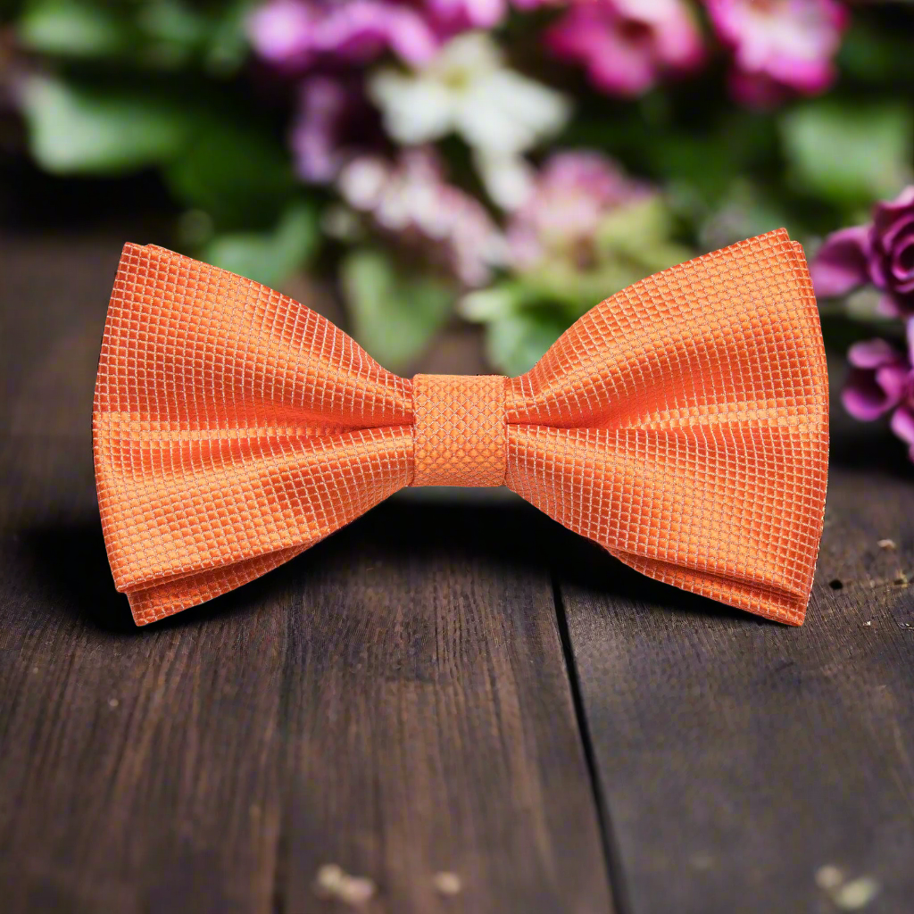 Elegant burgundy solid color bow tie paired with a crisp white shirt.