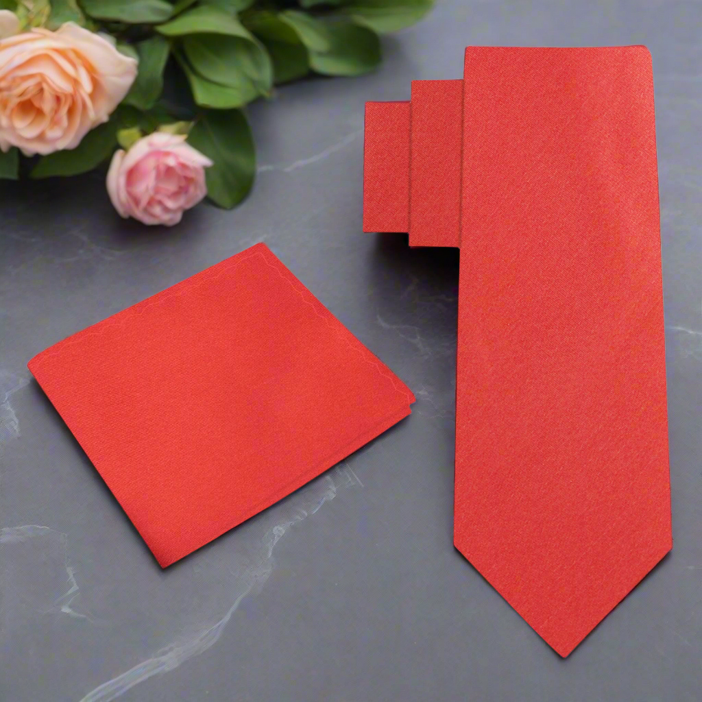 Close-up of Elegant Solid Red Silk Necktie draped over a suit jacket, highlighting its rich texture.