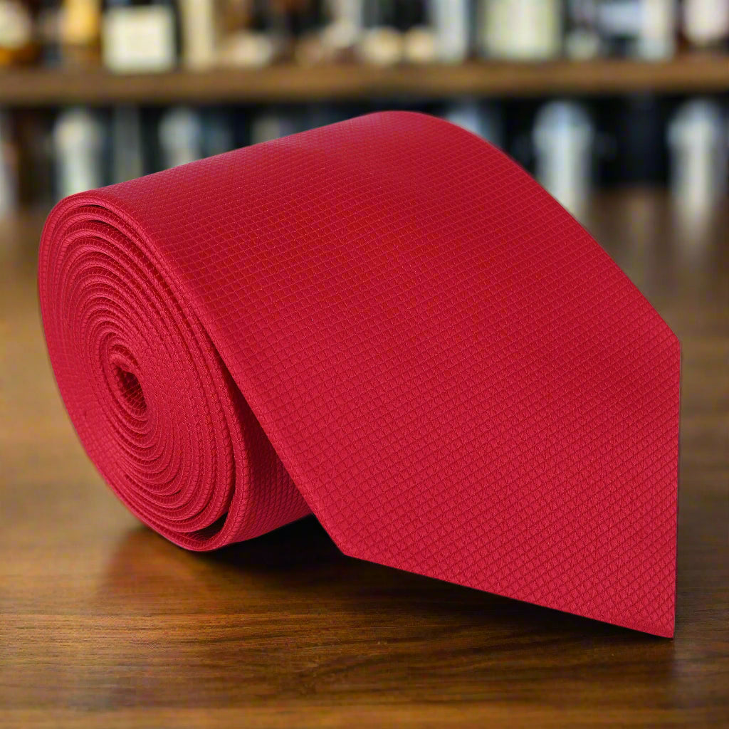 Close-up of a silk red tie with a sleek knot, ideal for formal occasions