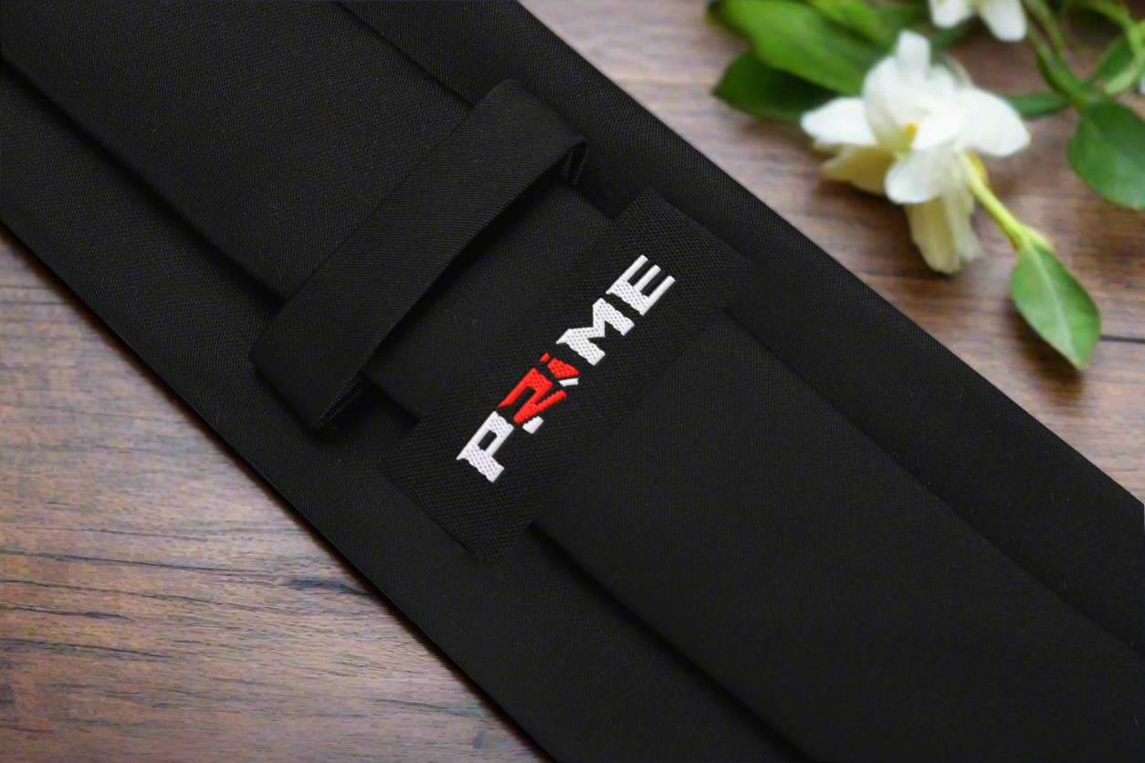 Man wearing a solid black necktie with a suit for a business meeting